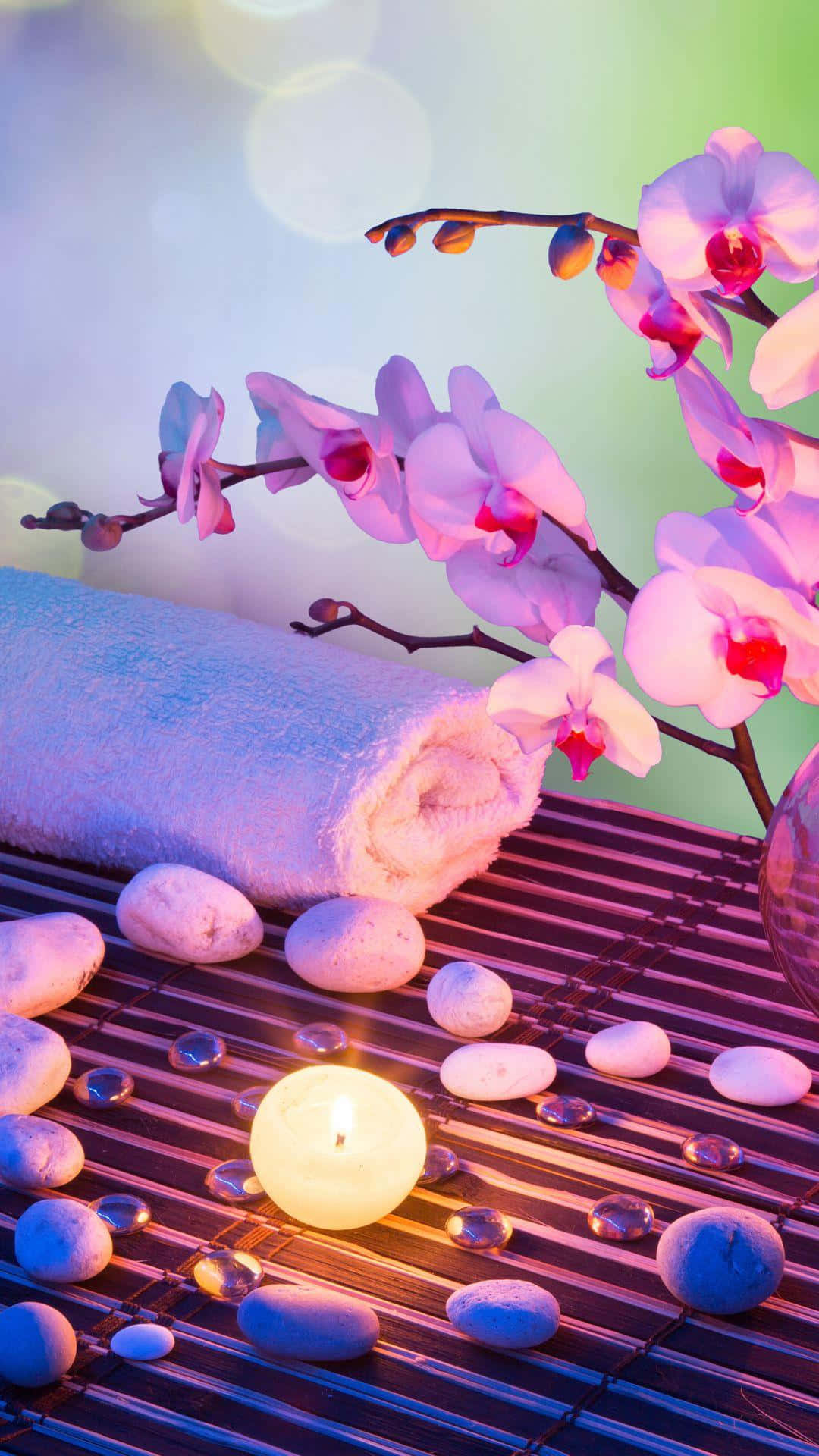 Tranquil Spa Settingwith Orchidsand Candle Background