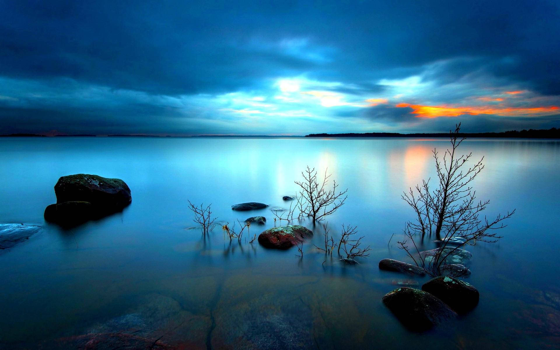 Tranquil Water Under The Dark Clouds Horizon