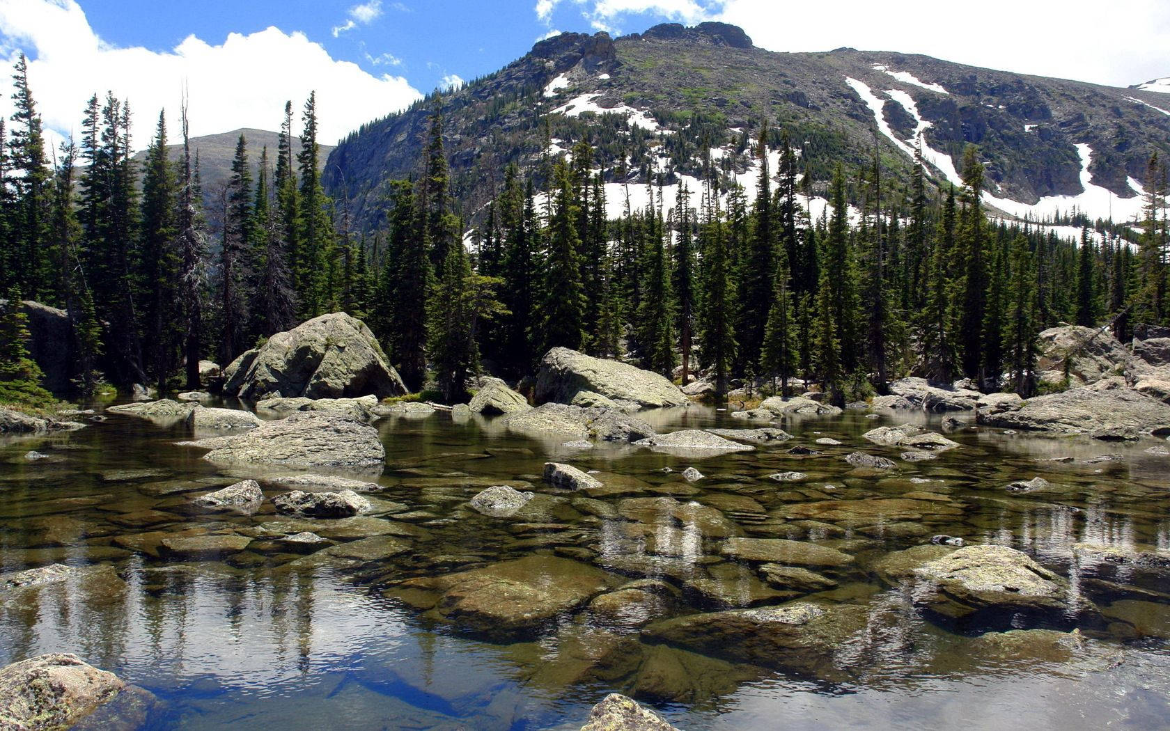 Transparent Lake With Rocks Background