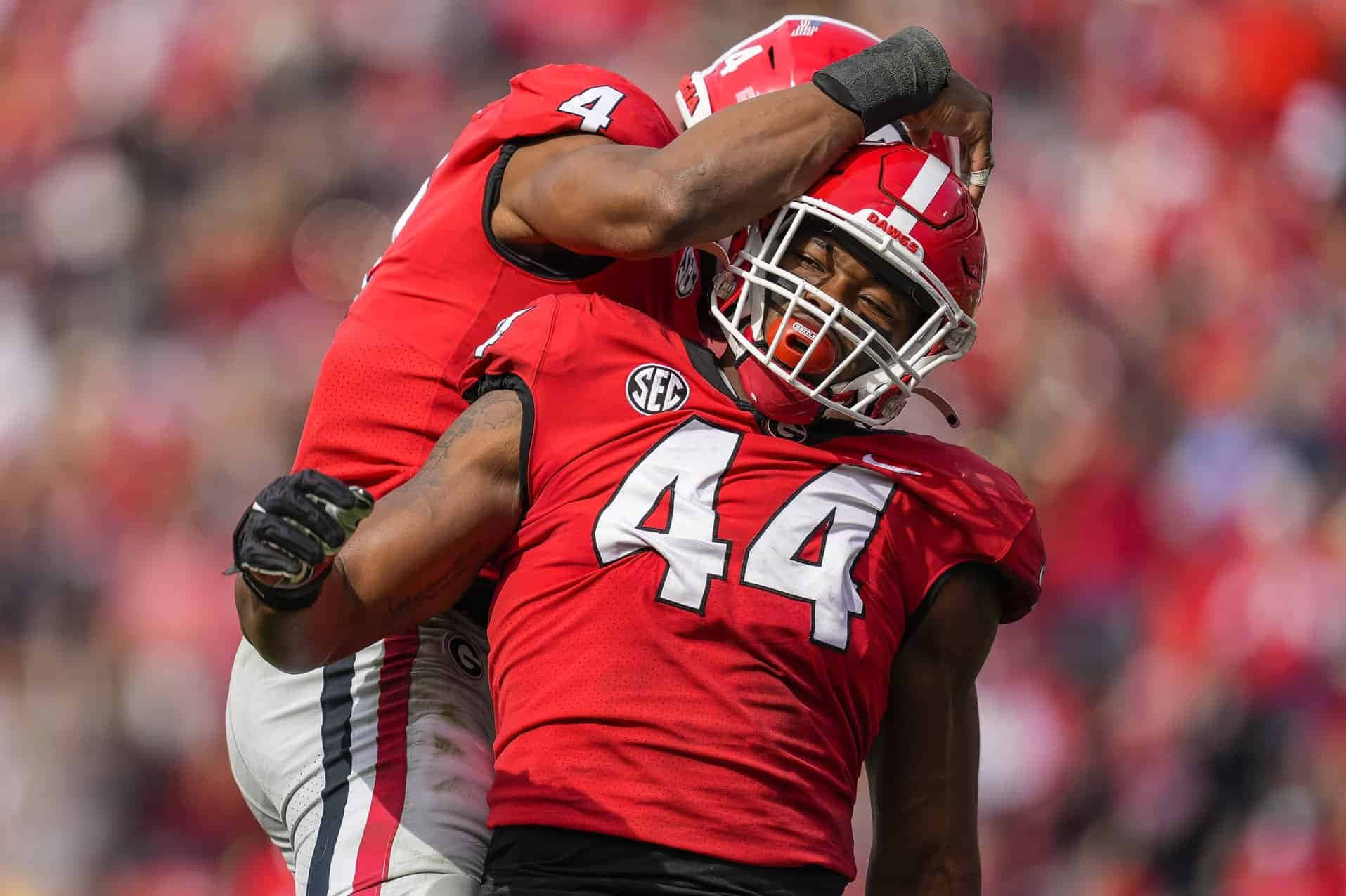 Travon Walker Gleefully Celebrating His Victory With A Teammate Background