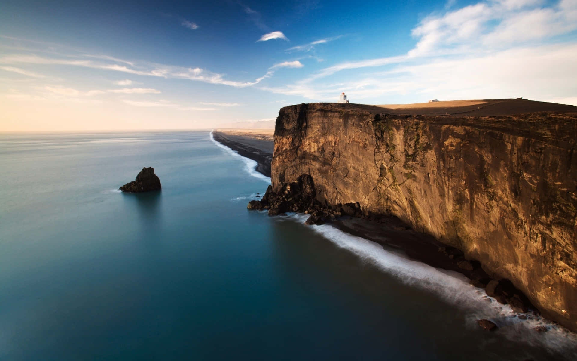 Tremendous Cliff Facing The Ocean Background