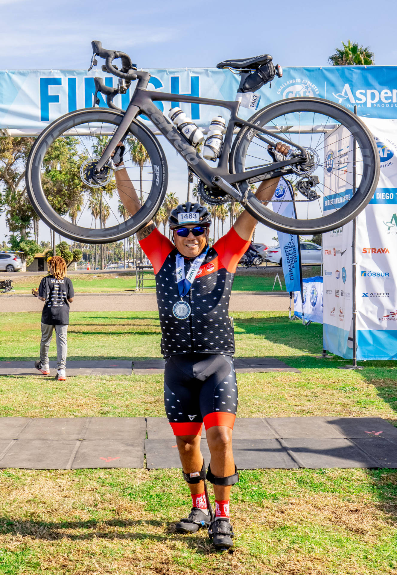 Triathlon Athlete Carrying His Bike