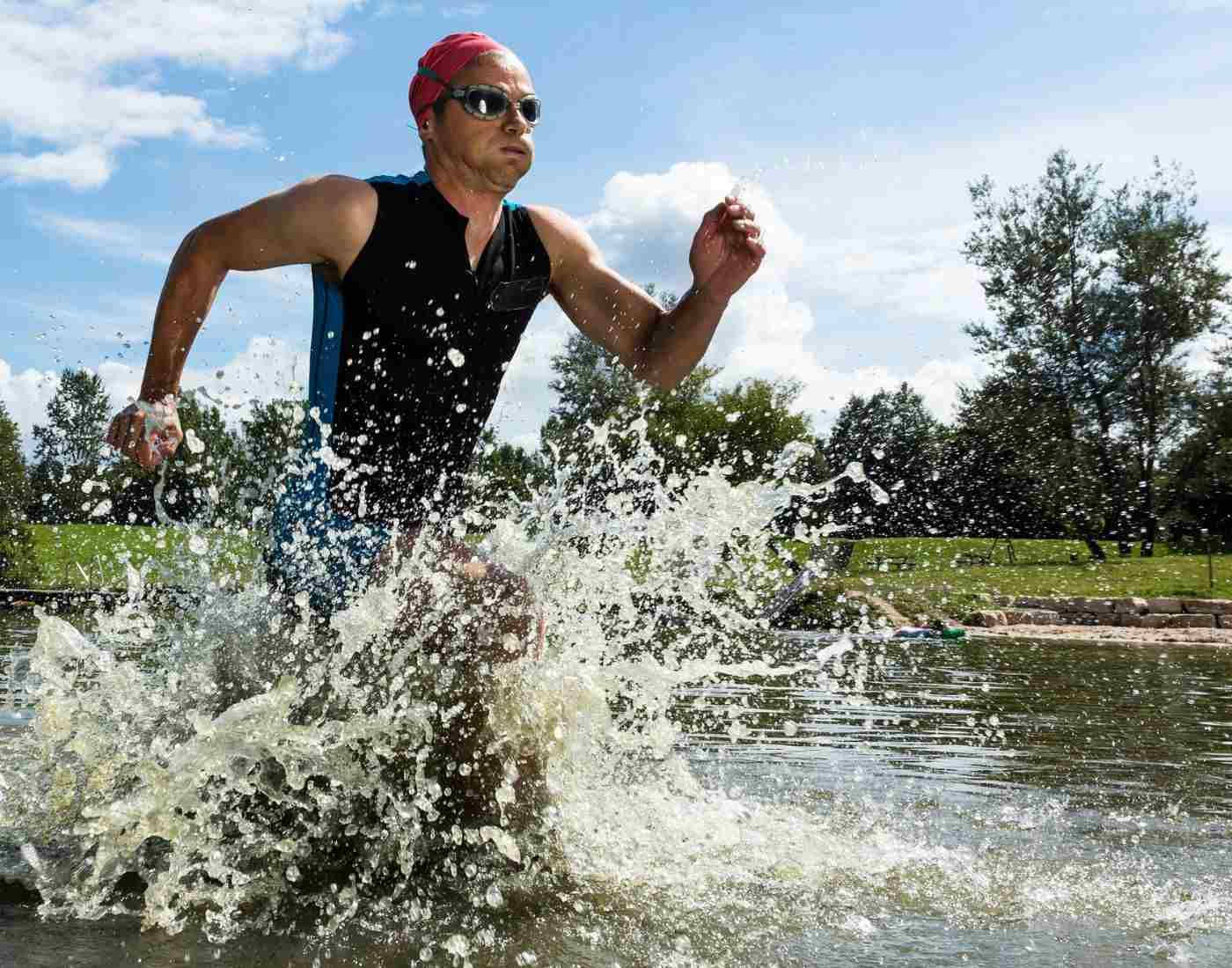 Triathlon Athlete Coming Out Of The Water Background