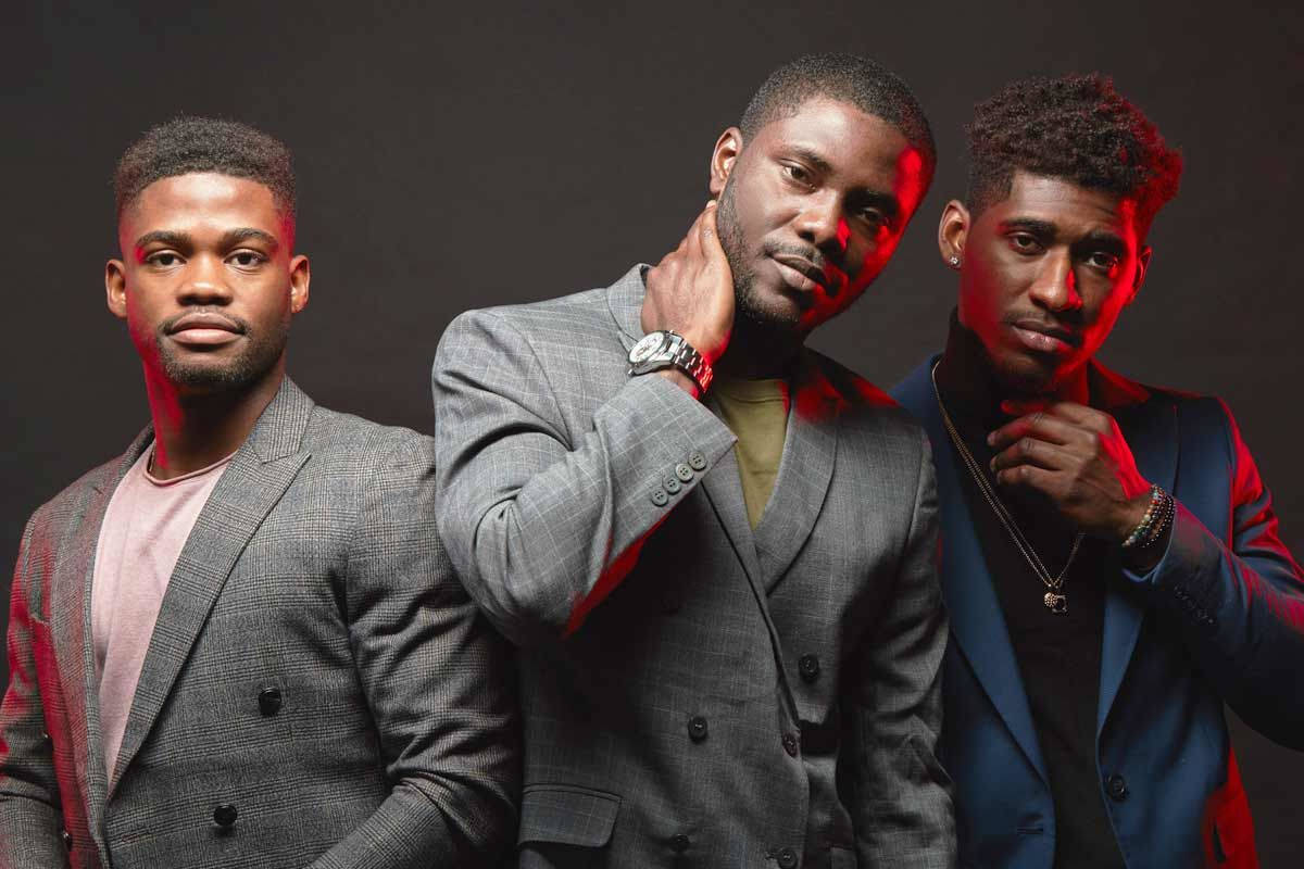 Trio Of Confidence: Distinguished Black Men In Modern Fashion Background