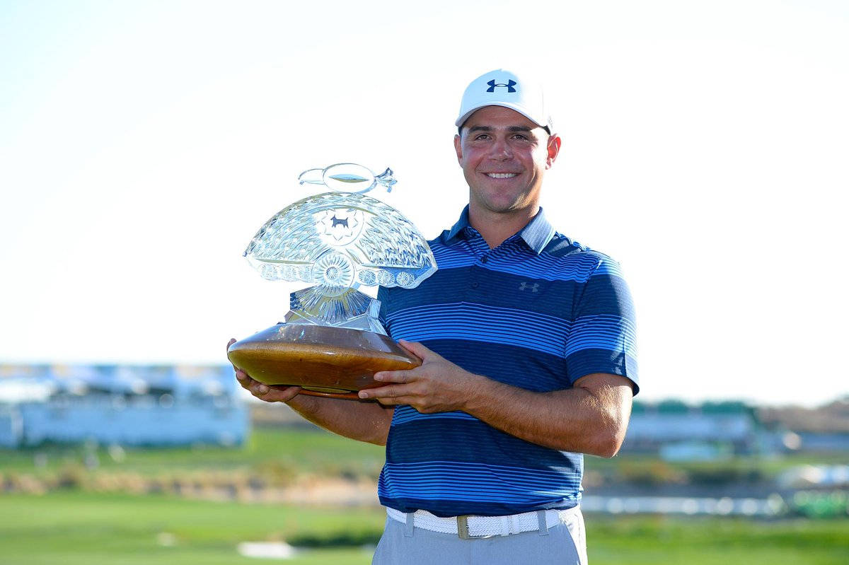 Triumph: Gary Woodland Proudly Holding His Golfing Trophy Background