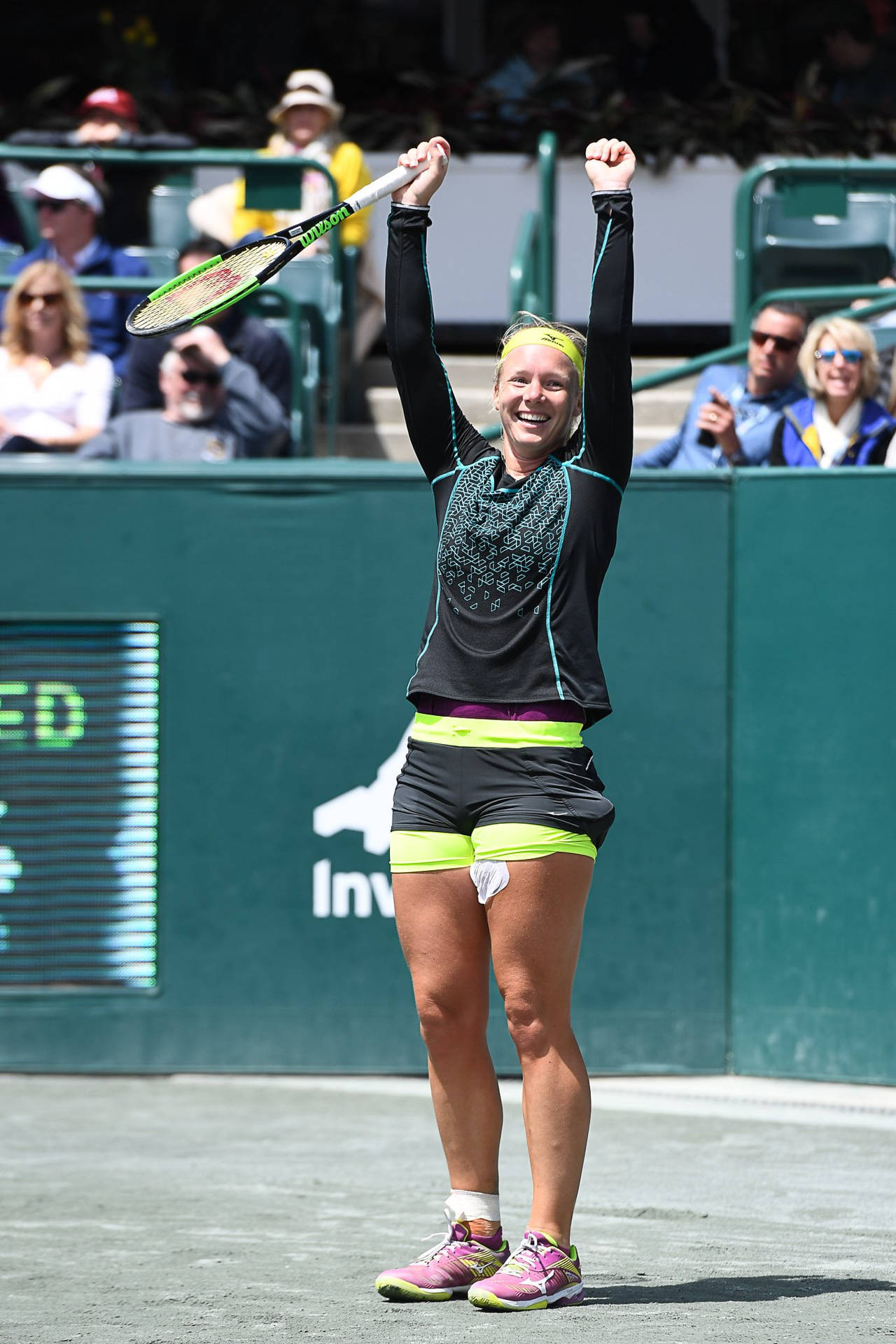 Triumphant Kiki Bertens With Arms Raised Celebrating Victory Background