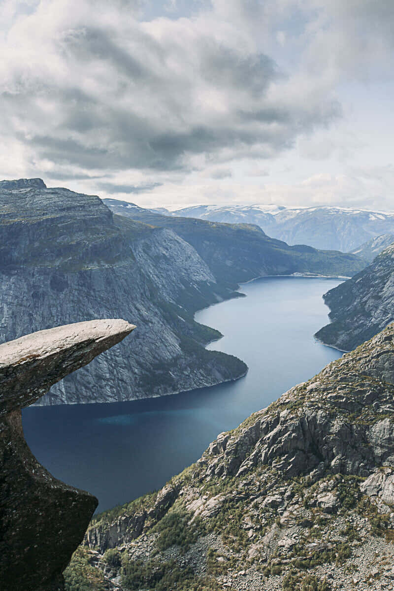 Trolltunga In Dim And Cloudy Weather Background