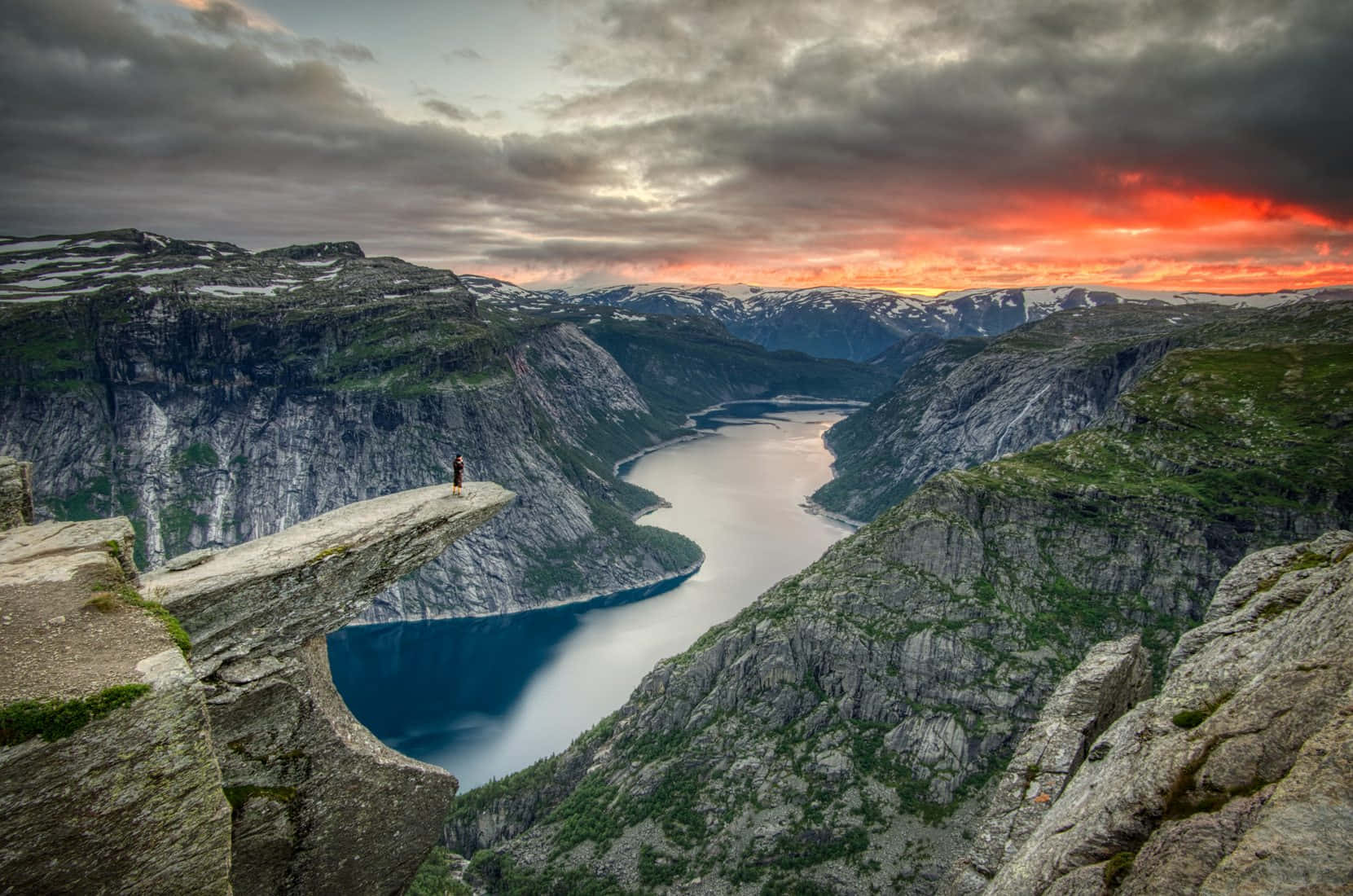 Trolltunga With Bright Orange Sunset Background