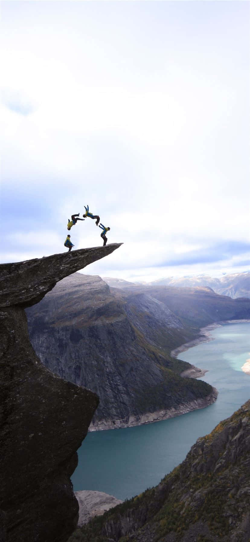 Trolltunga With Tourists Doing Backflips Background