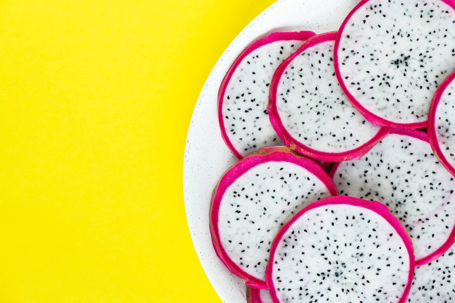 Tropical Feast: Fresh And Juicy Dragonfruit Sliced Open On A Plate. Background