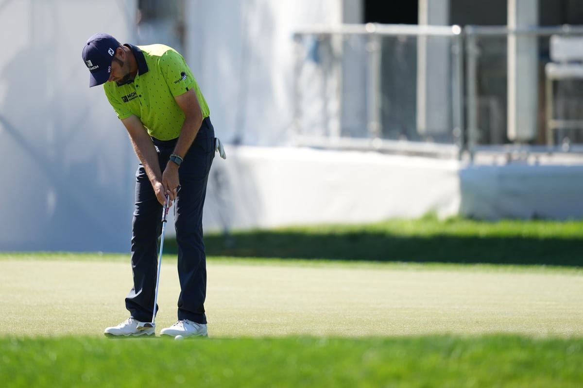 Troy Merritt Bending Down Aiming Ball Background