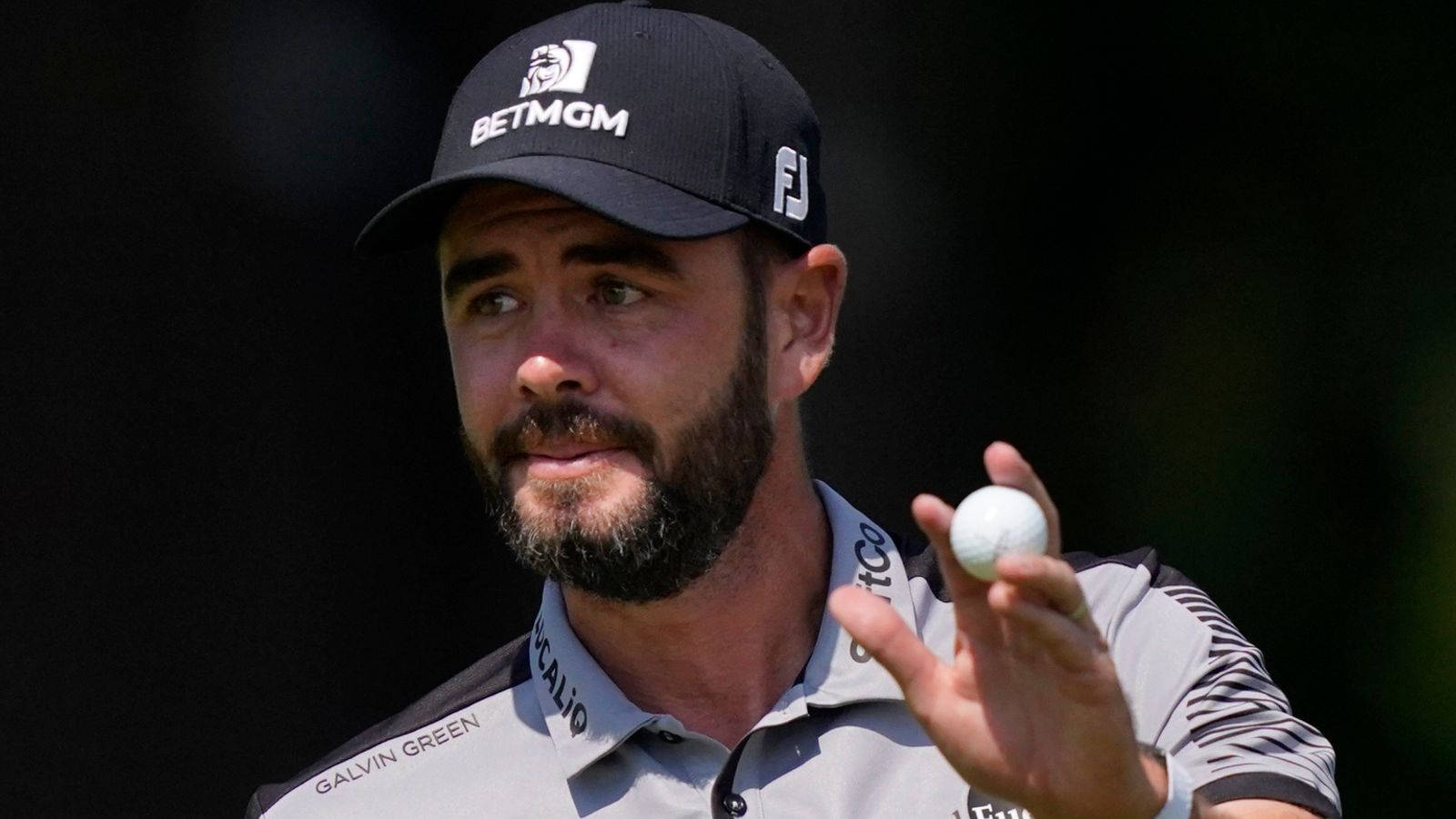 Troy Merritt Golf Ball In Hand Background