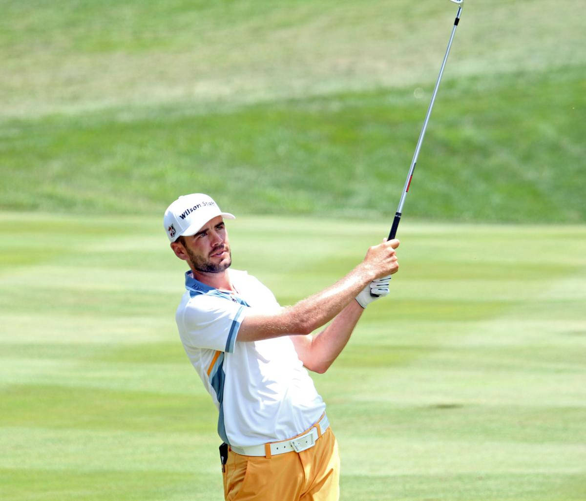 Troy Merritt Holding Golf Club Up