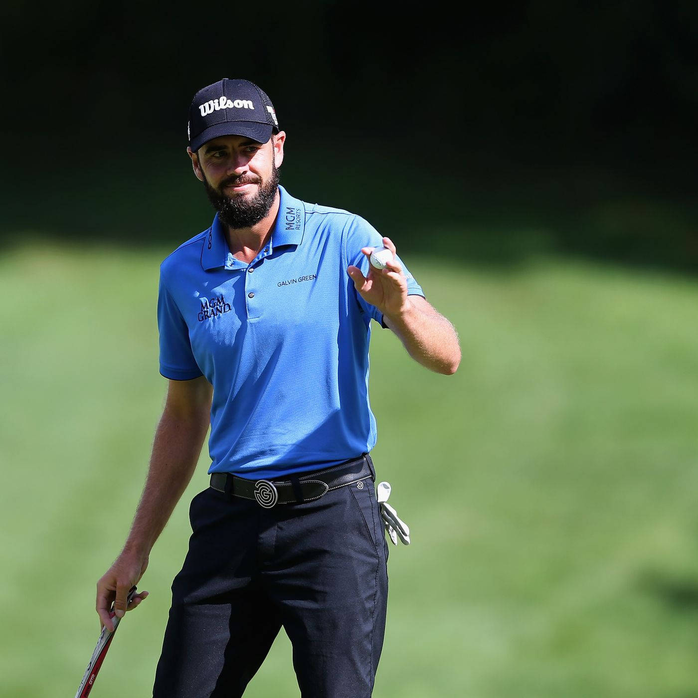 Troy Merritt Holding White Golf Ball Background