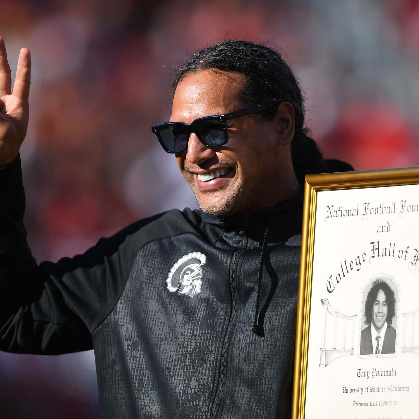 Troy Polamalu Showing Off His Iconic Hair During A Game With The Pittsburgh Steelers Background