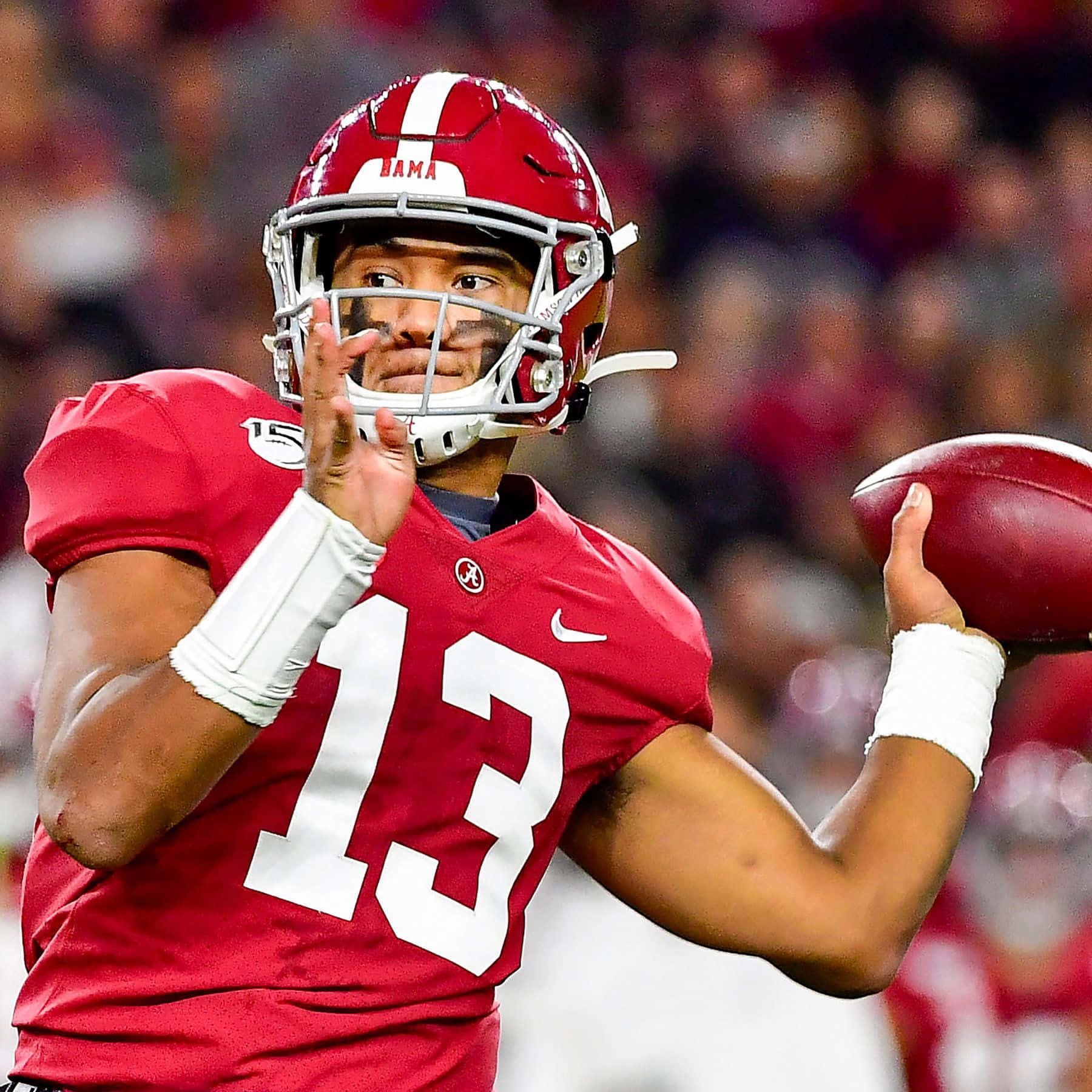 Tua Tagovailoa In Action On The Football Field Background