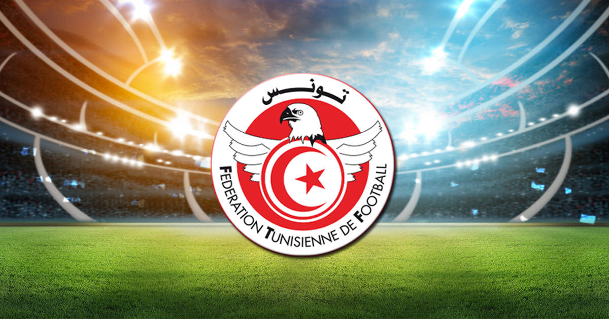 Tunisia National Football Team Logo In Football Stadium Background