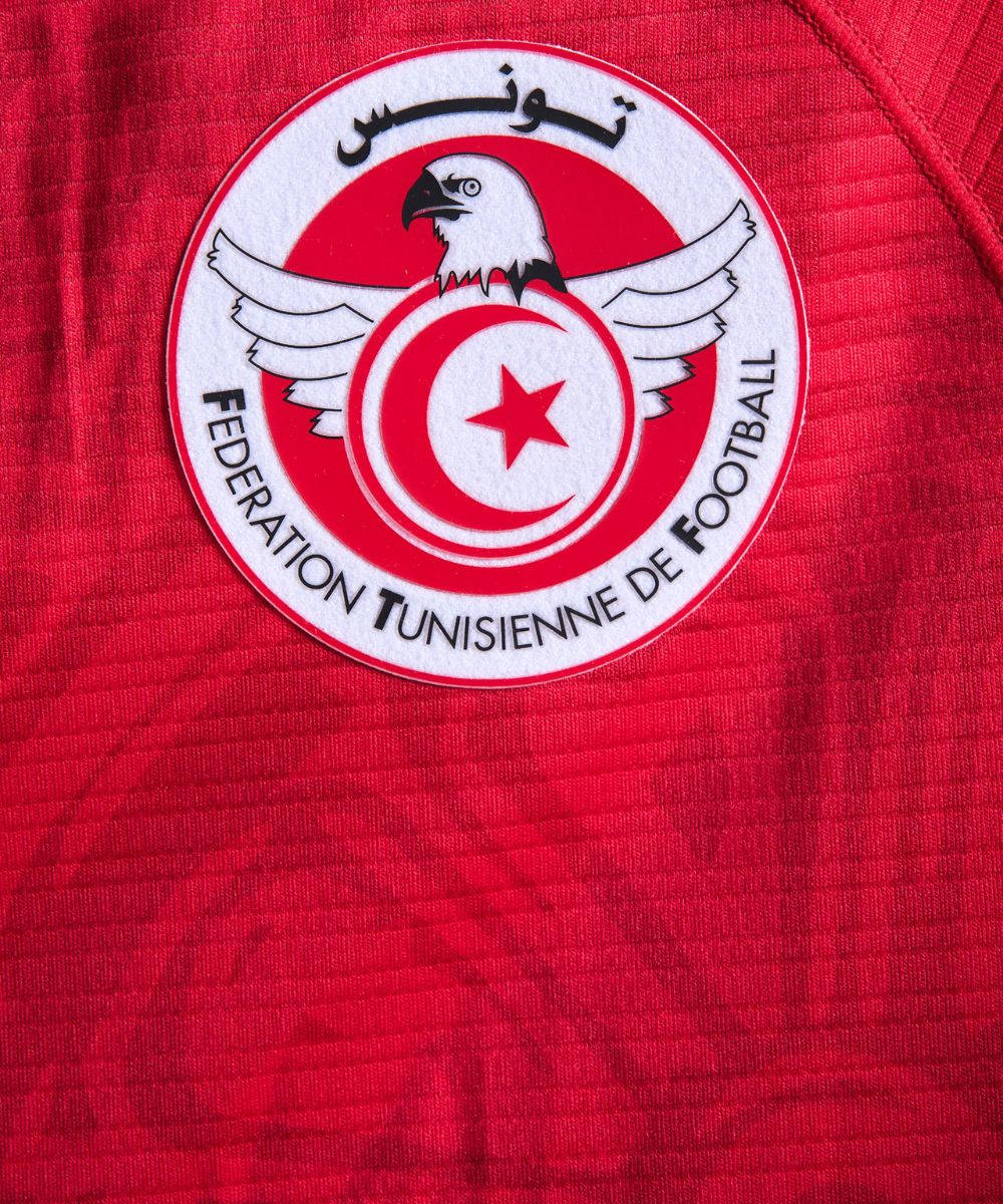 Tunisia National Football Team Logo In Red Jersey Background