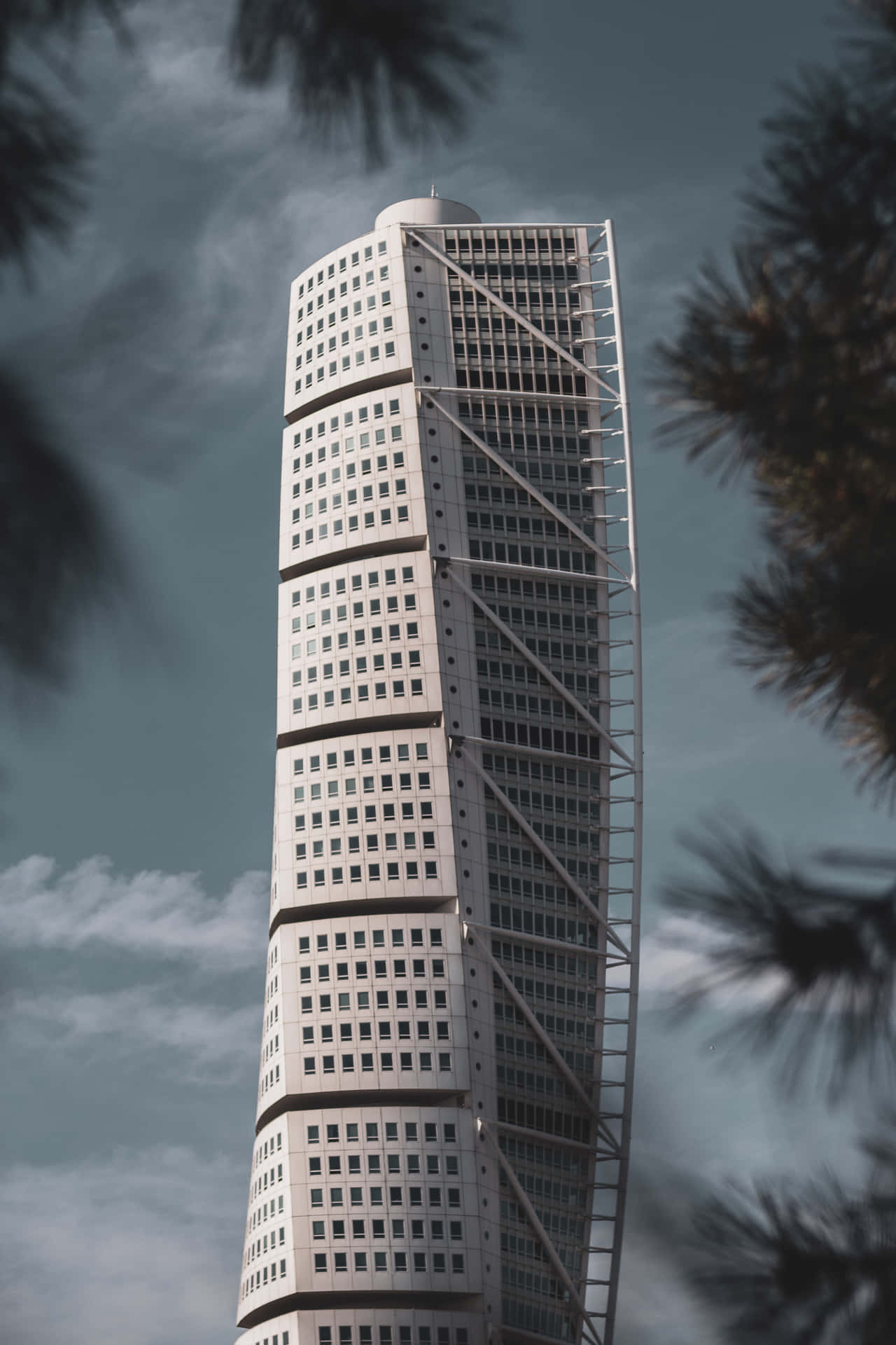 Turning Torso Phone Surrounded By Trees Background
