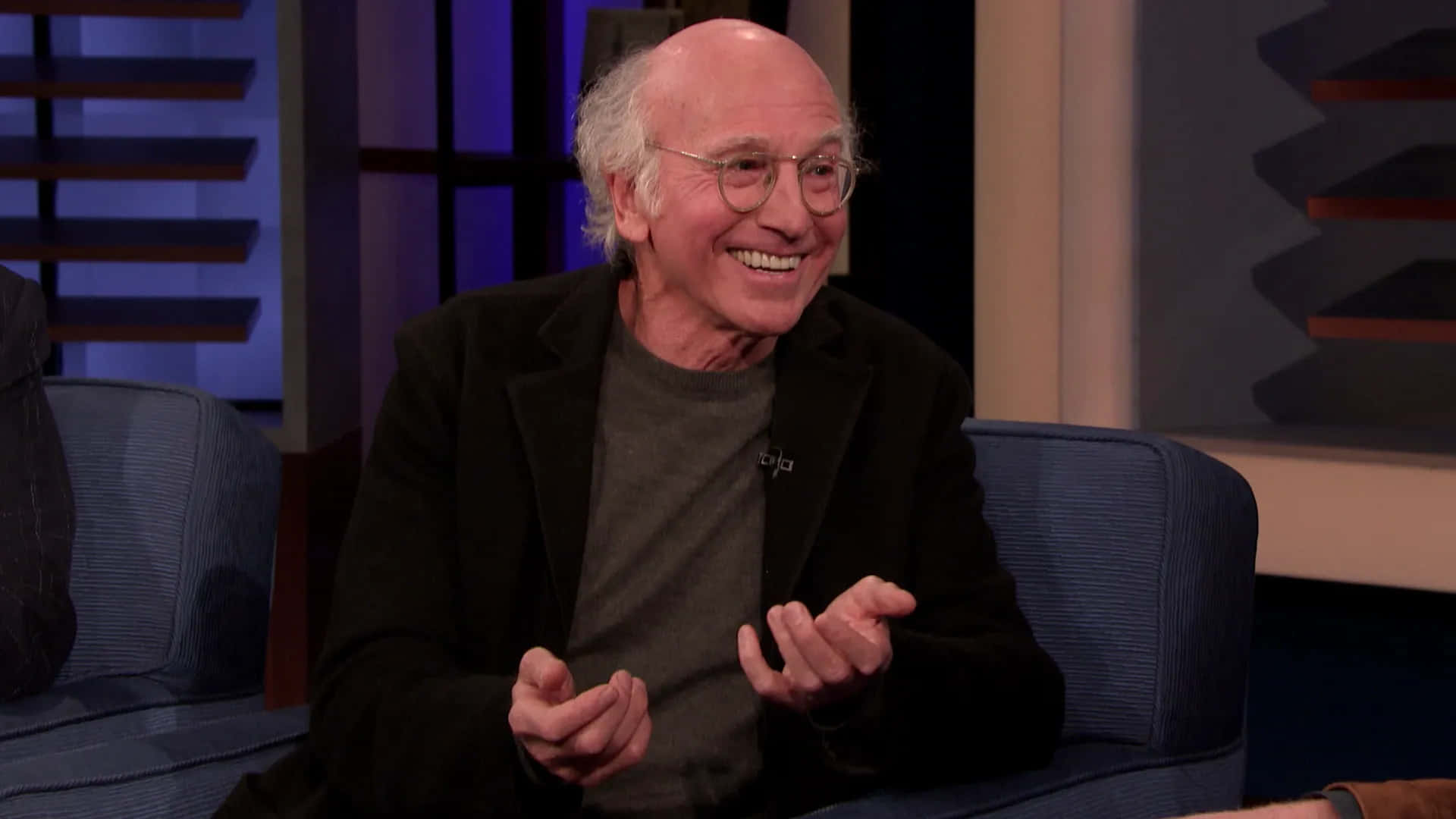 Tv Industry Icon Larry David In Thought Background
