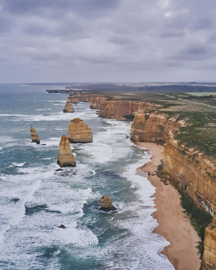 Twelve Apostles In Victoria Australia With Heavy Clouds Background