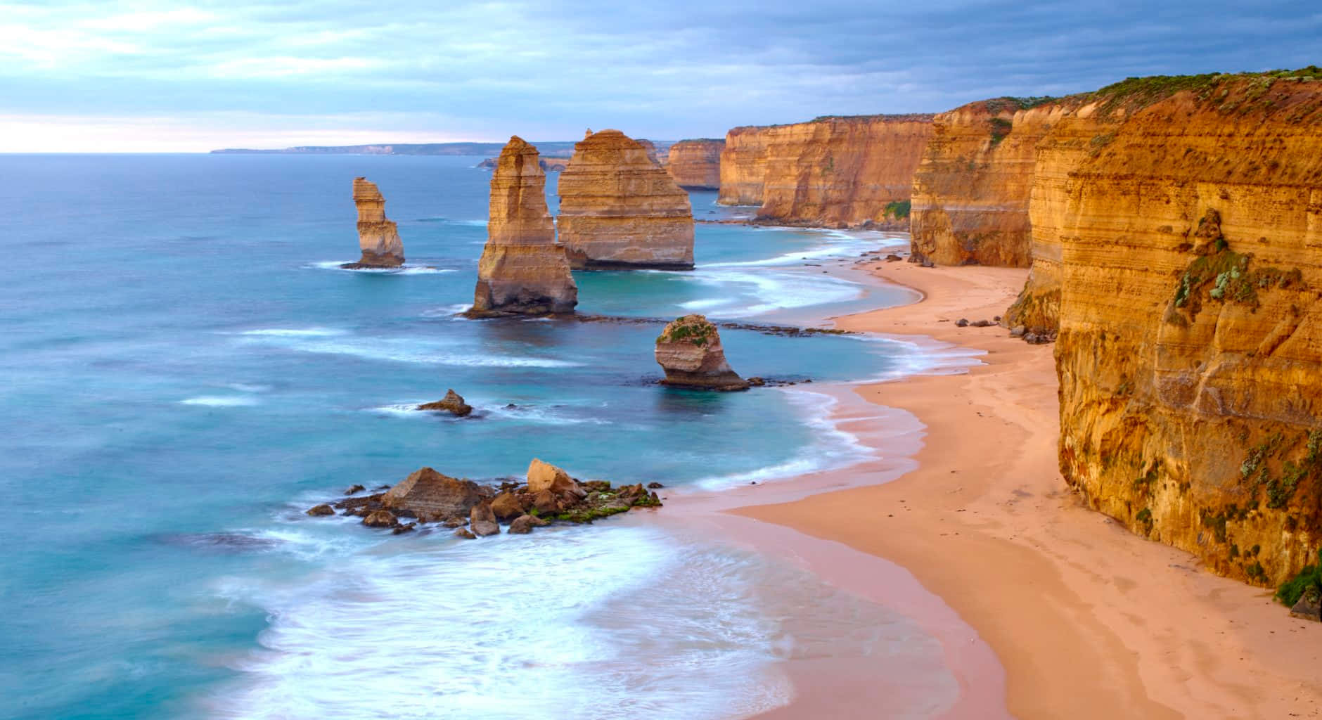 Twelve Apostles With Calm Waves In Victoria Australia Background