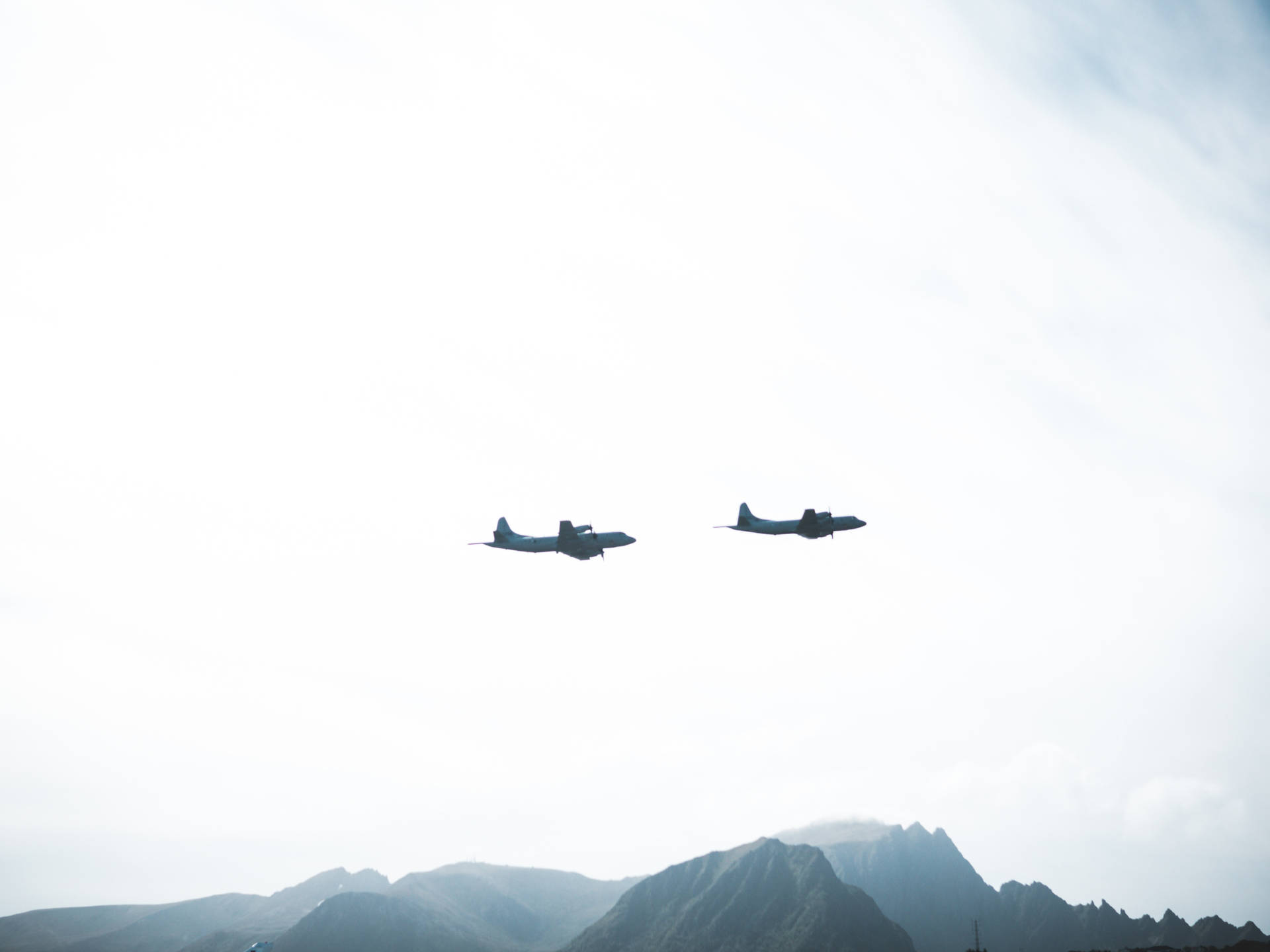 Twin Fighter Planes Soaring Through The Sky Background