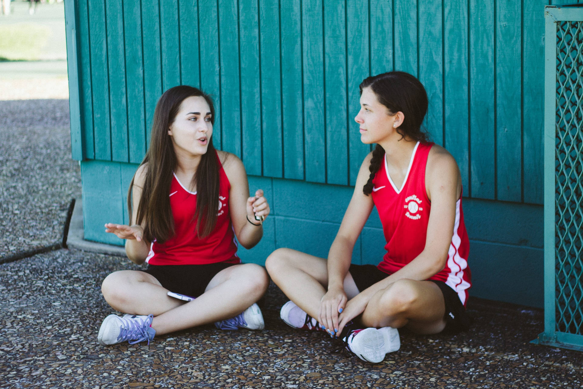 Two Athletes Teenage Girls Talking Background