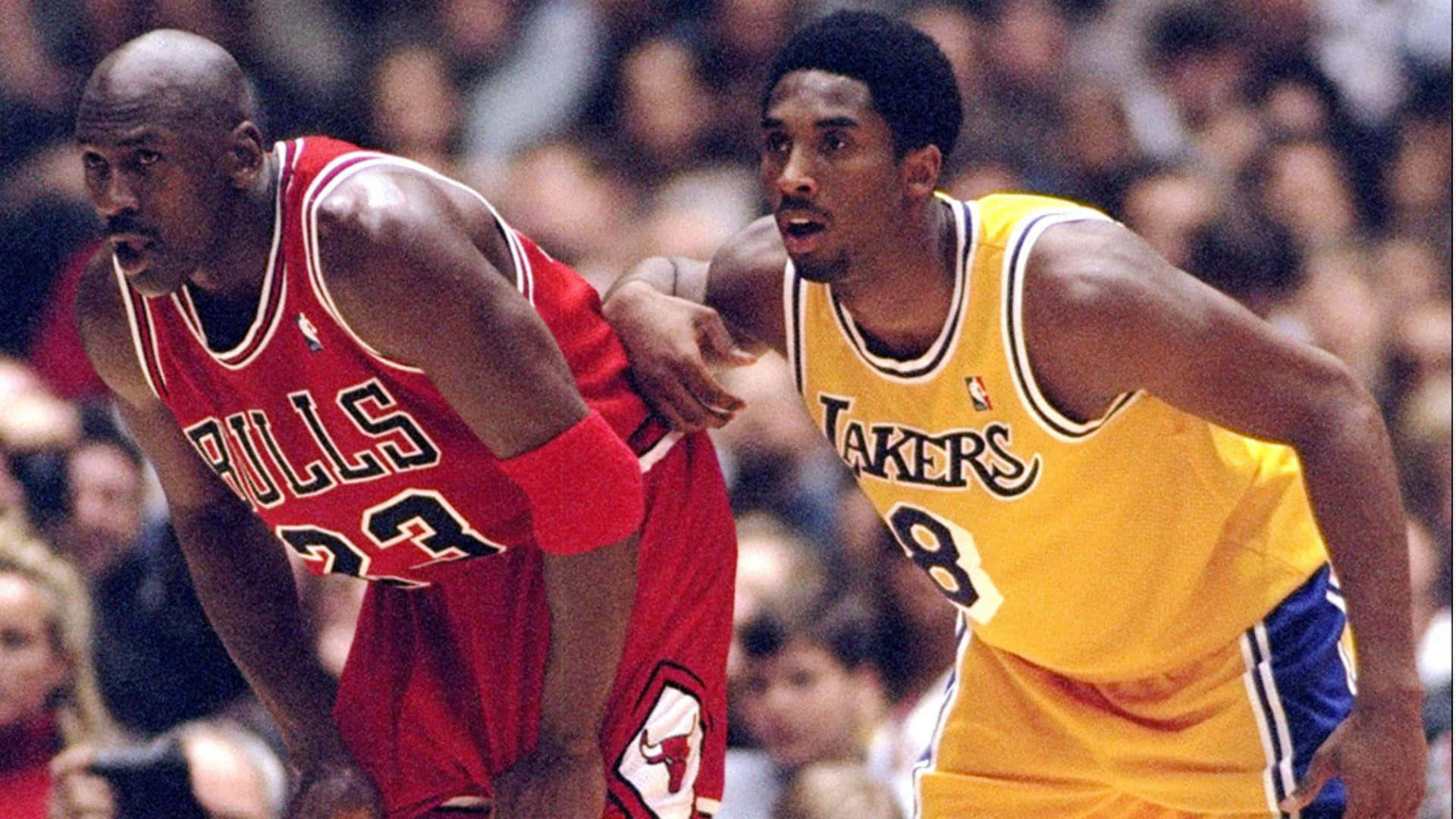Two Basketball Legends, Kobe Bryant And Michael Jordan, Embracing Each Other In A Show Of Mutual Respect. Background