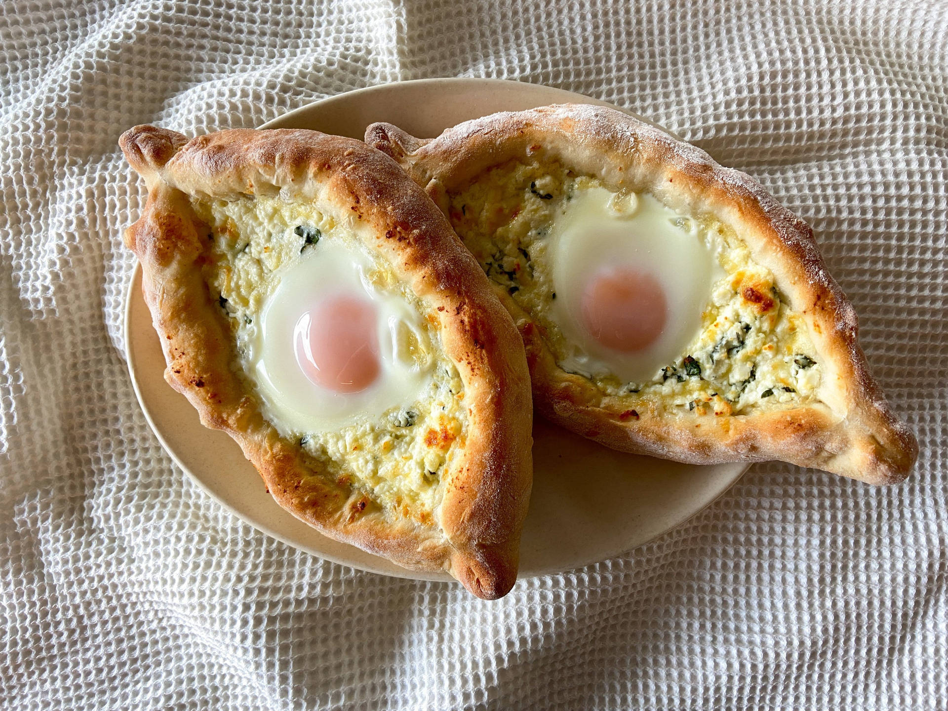 Two Beautifully Baked Georgian Khachapuri Breads Background