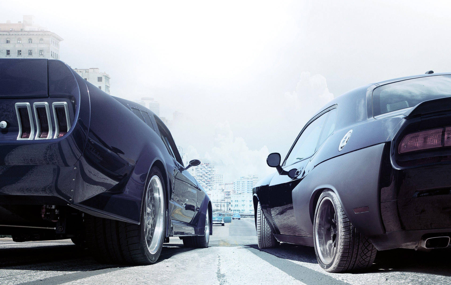 Two Black Cars Are Parked On A Street Background