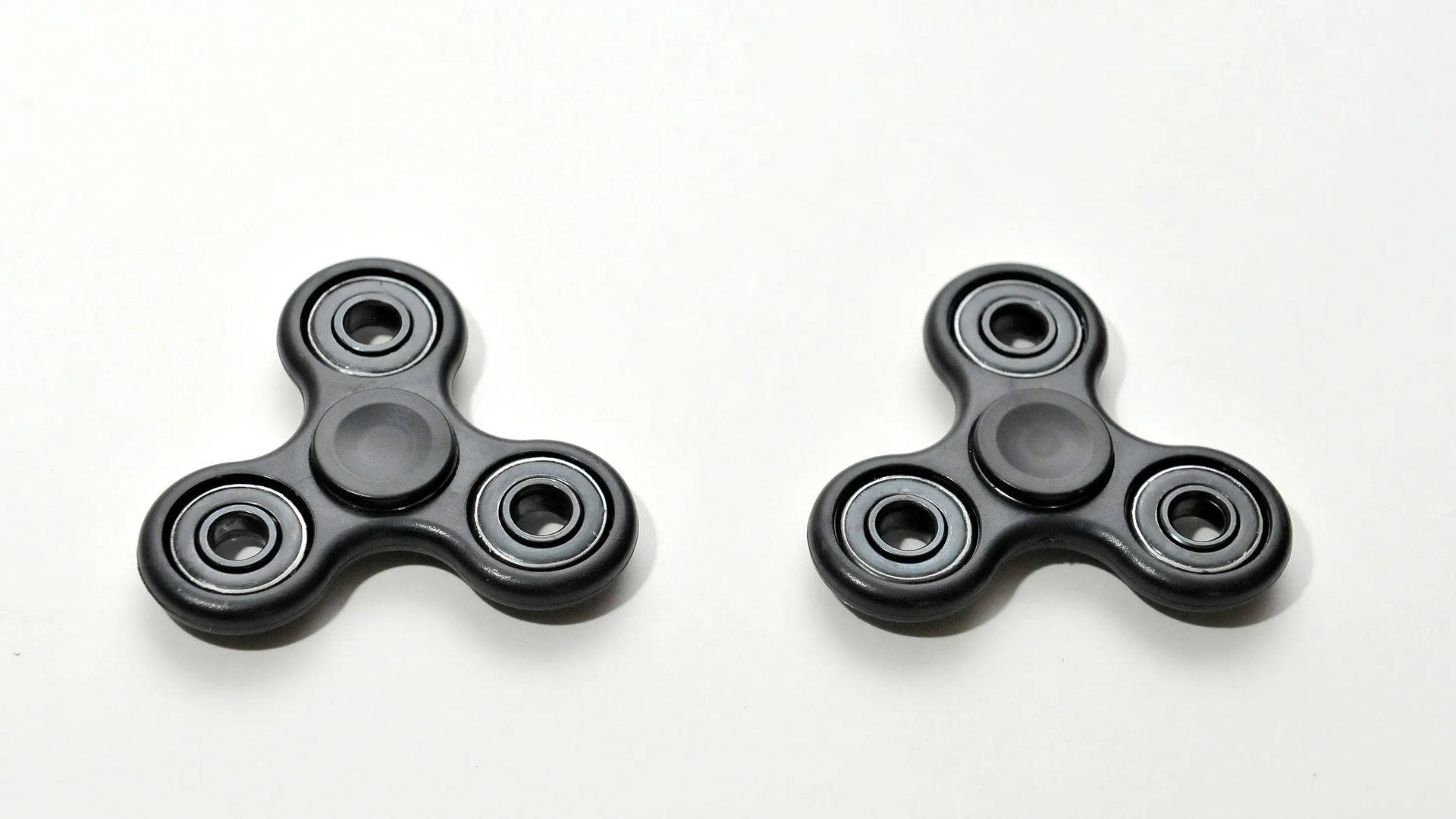 Two Black Fidget Toys Background