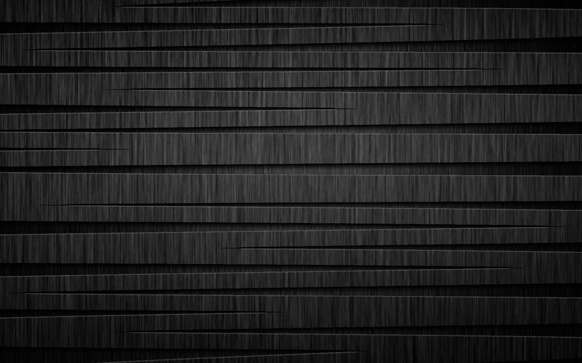 Two Black Metallic Cylinders Lying Against A White Backdrop Background