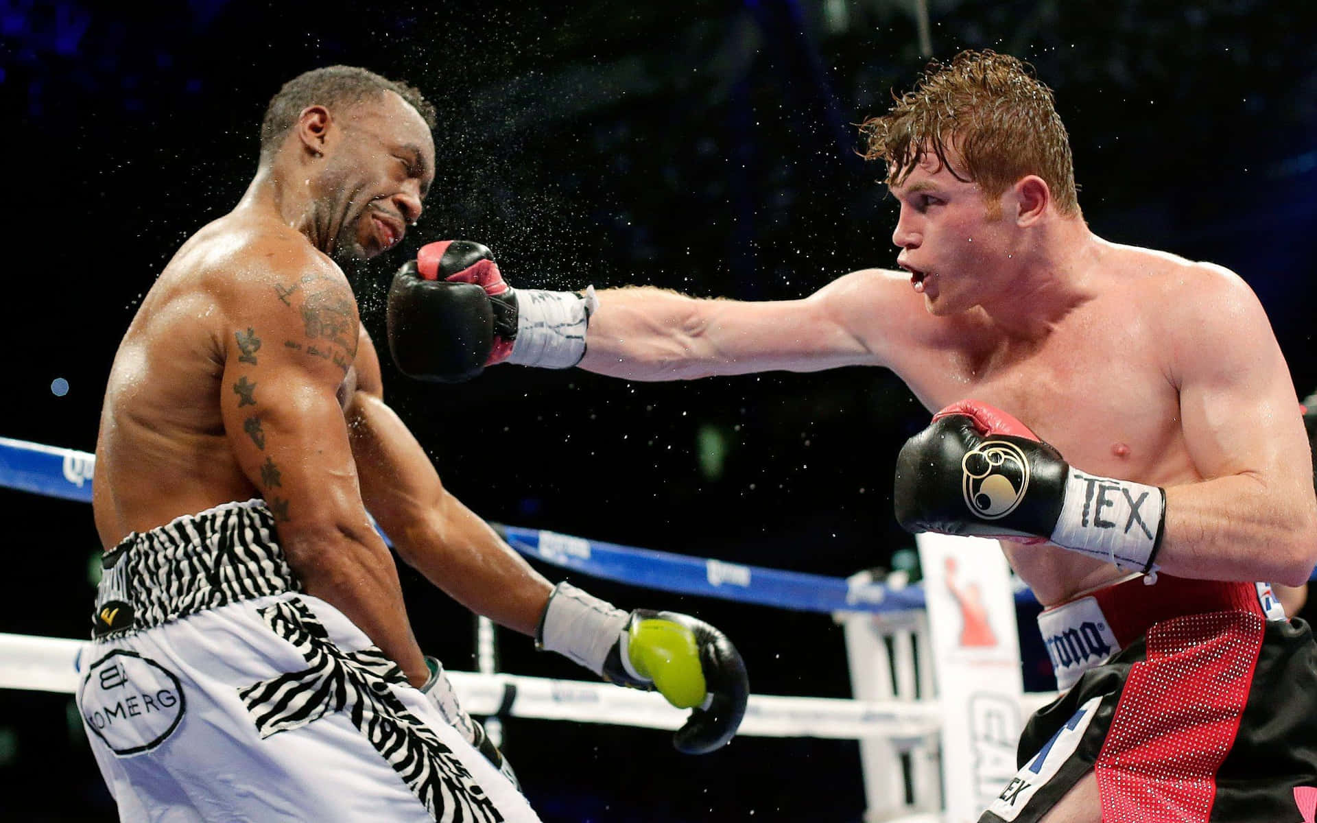 Two Boxers In Action In A Boxing Ring Background