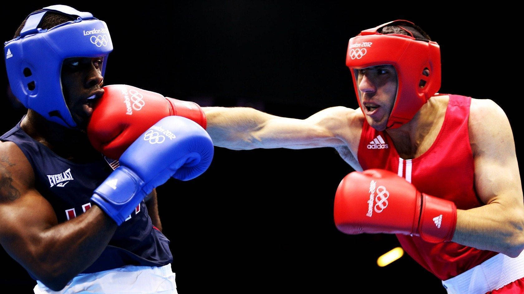 Two Boxers In Blue And Red Fighting In A Boxing Ring Background