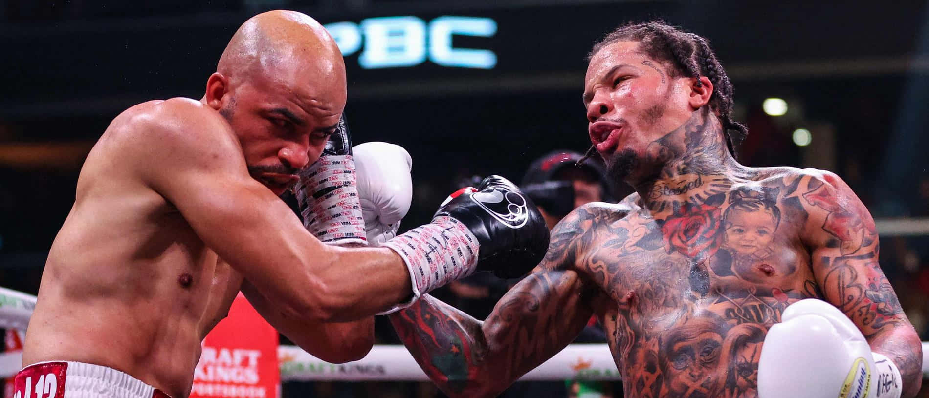 Two Boxers With Tattoos Fighting In A Boxing Ring Background