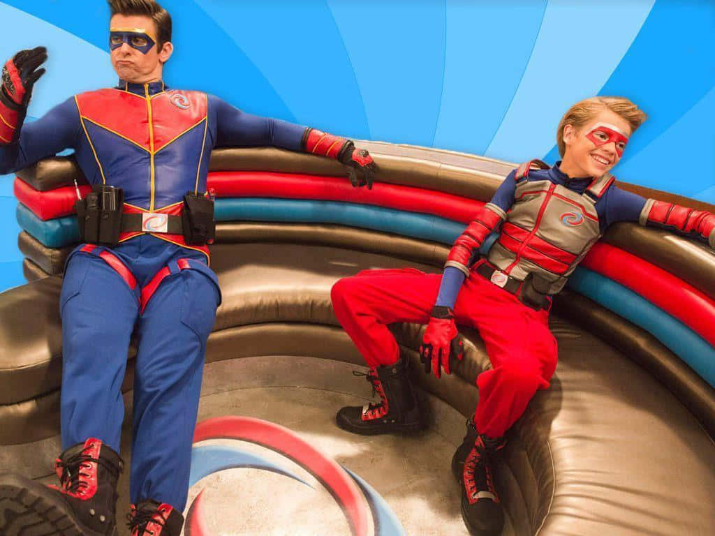 Two Boys In Superhero Costumes Sitting On A Couch