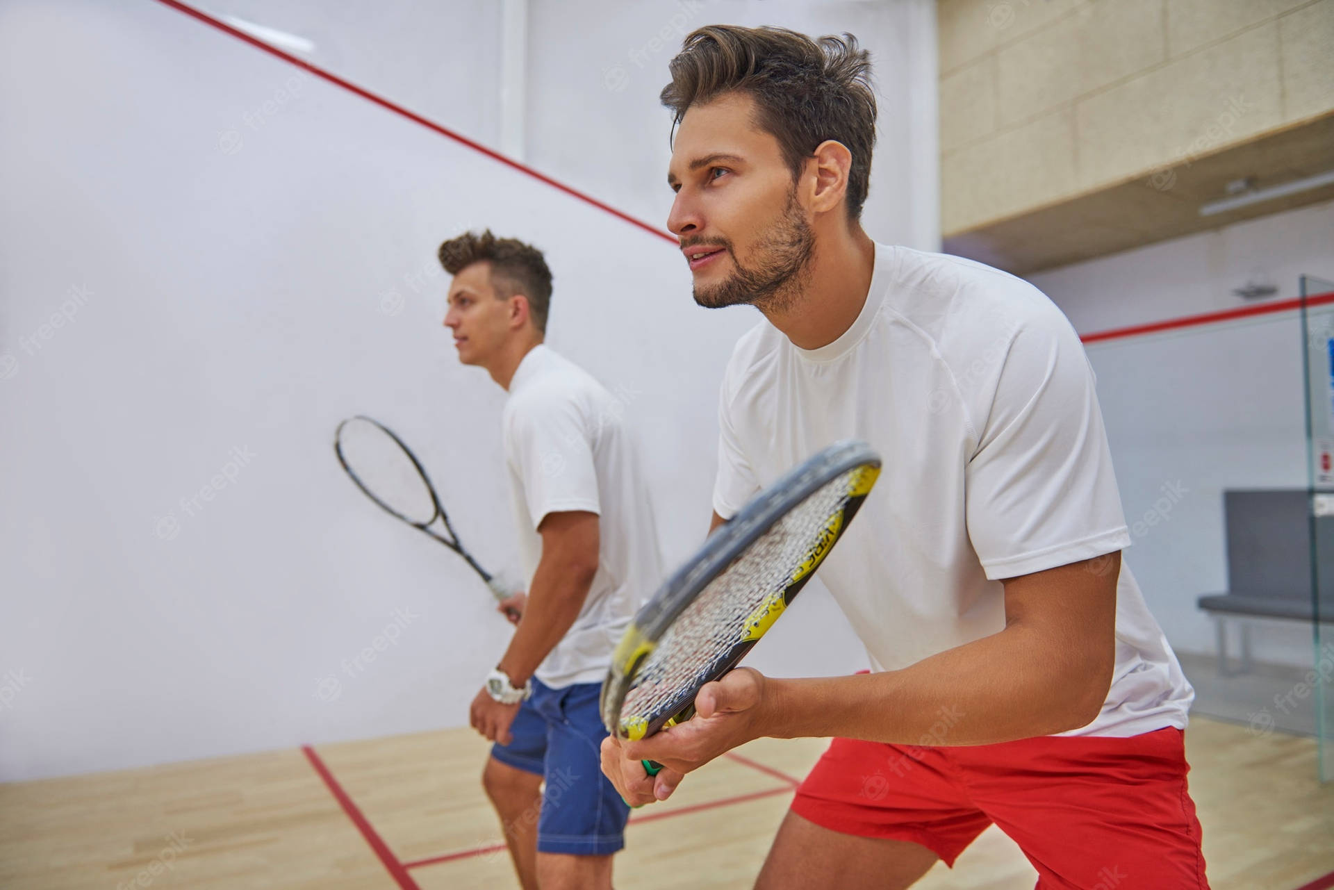 Two Boys In White Playing Squash