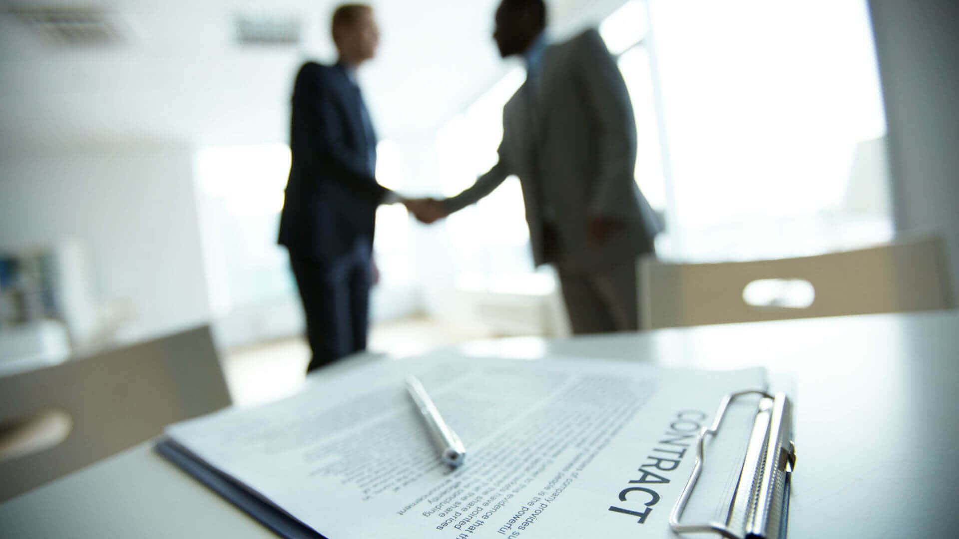 Two Businessmen Finalizing Contract Agreement Background