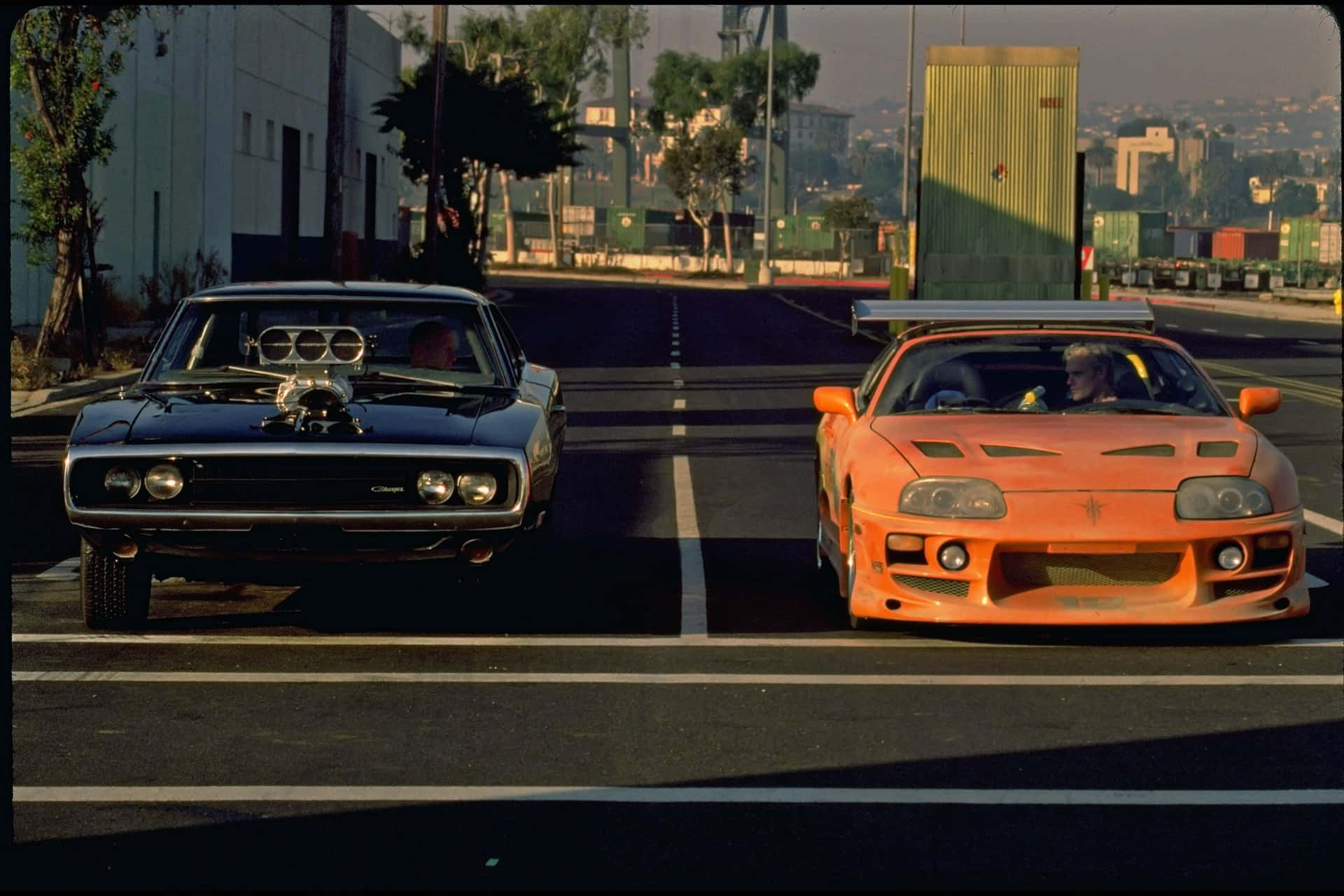 Two Cars Racing In Fast And Furious 1 Background