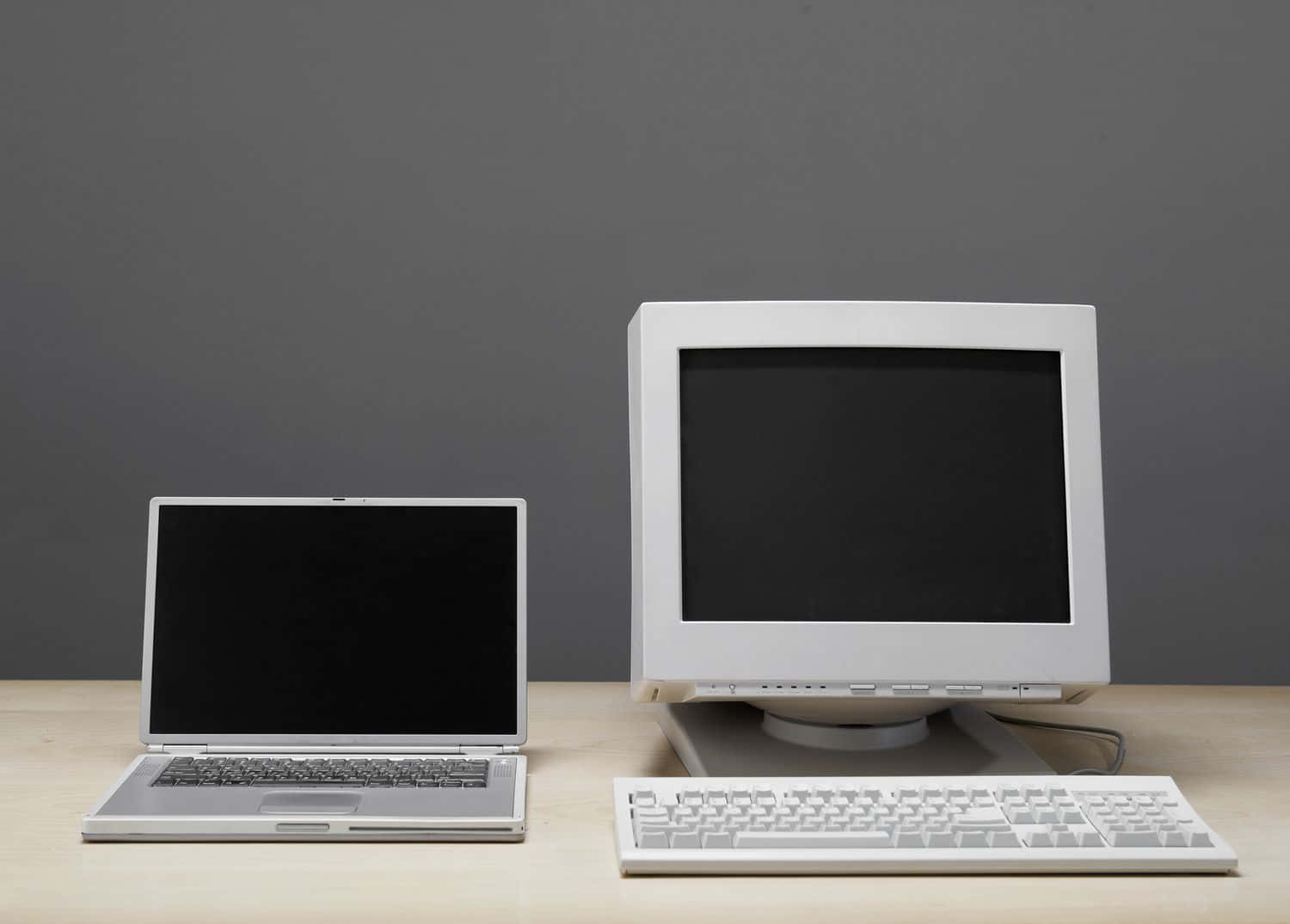 Two Computers On A Table With A Keyboard Background