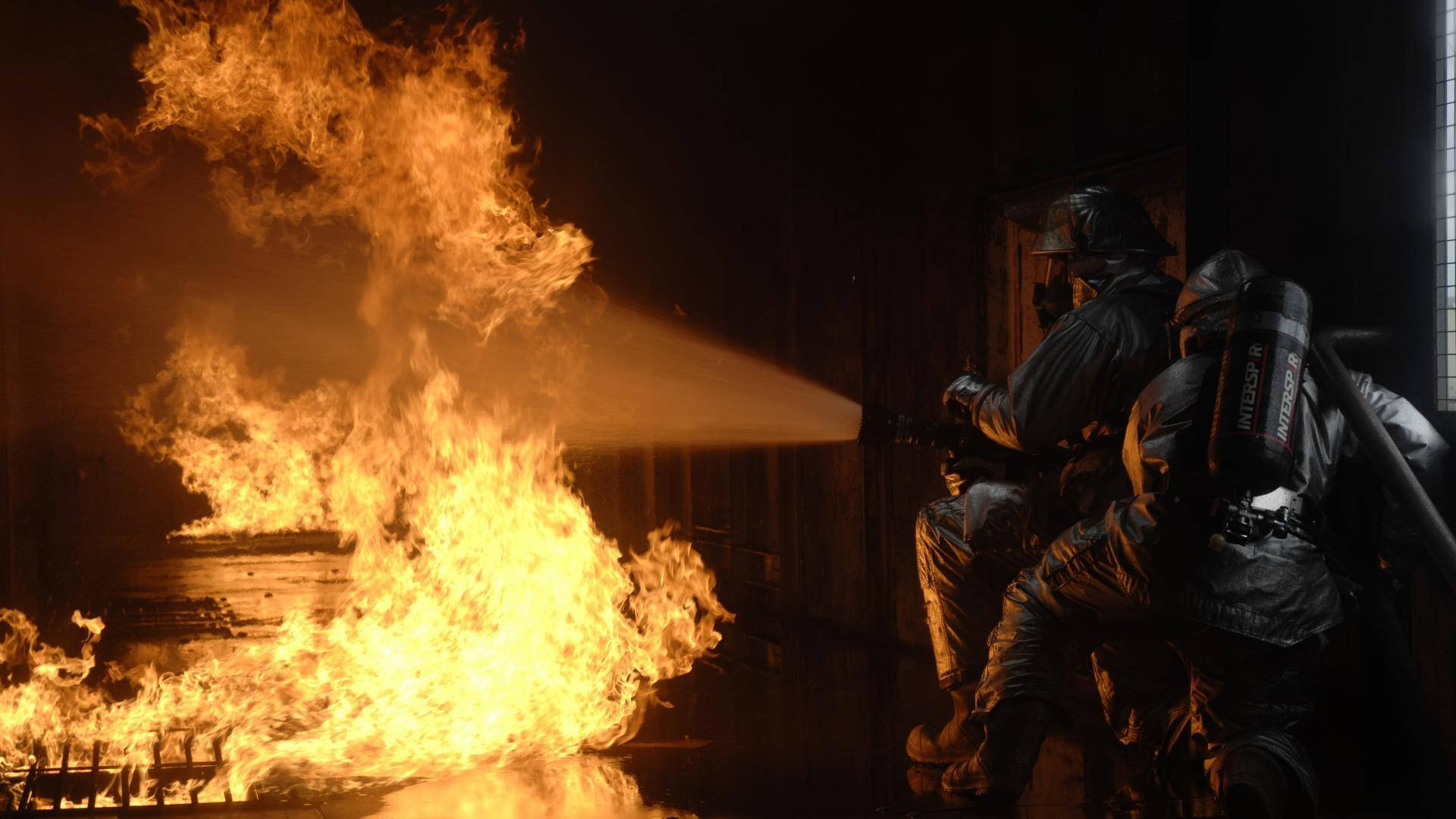 Two Firefighters Putting Out Fire