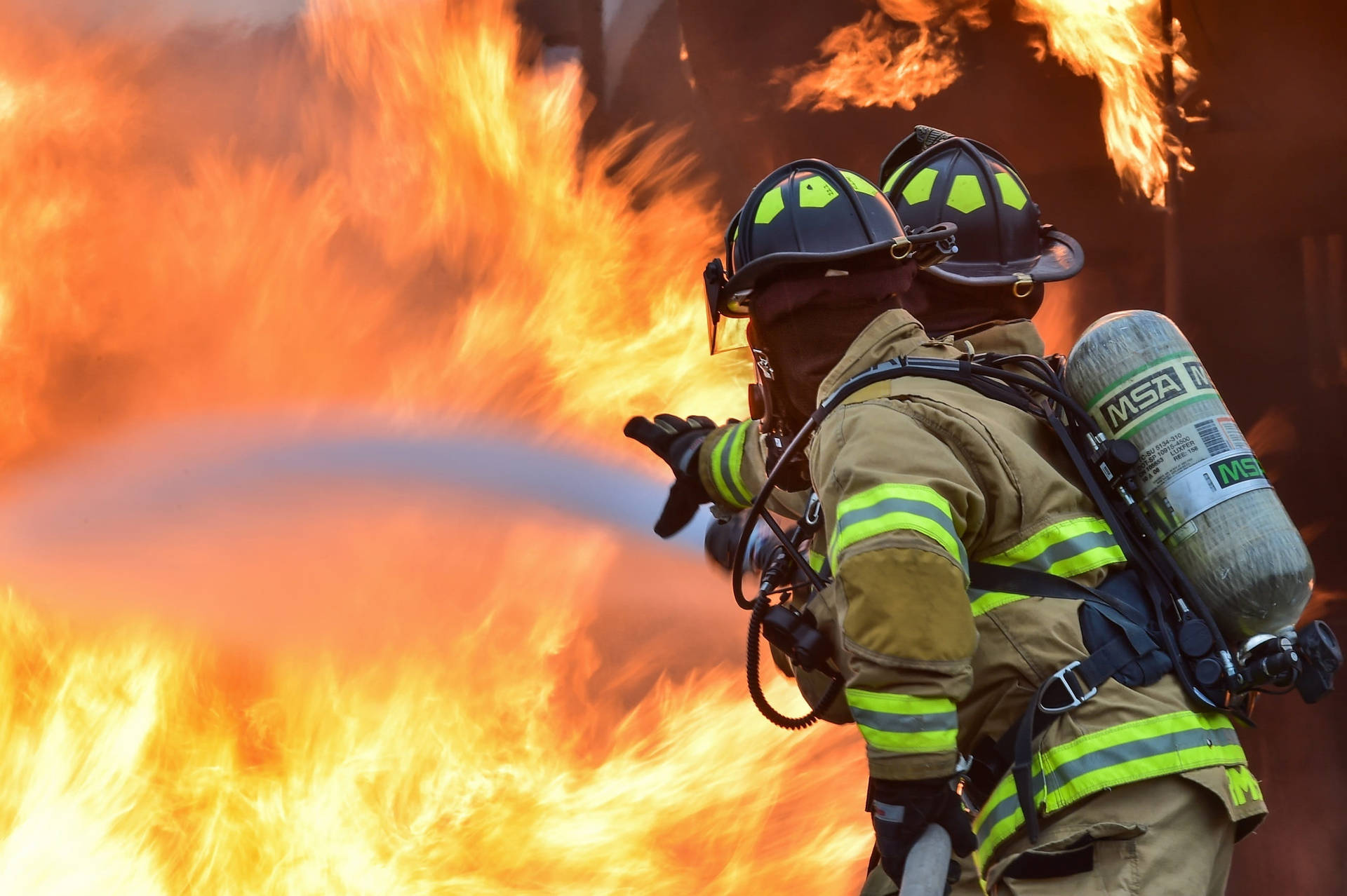 Two Firefighters Responding To A Fire Background