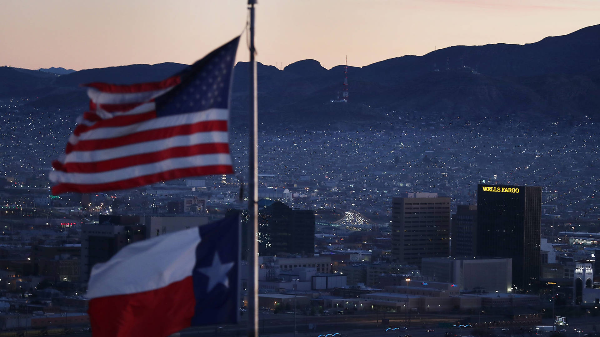 Two Flags Waving In El Paso Background