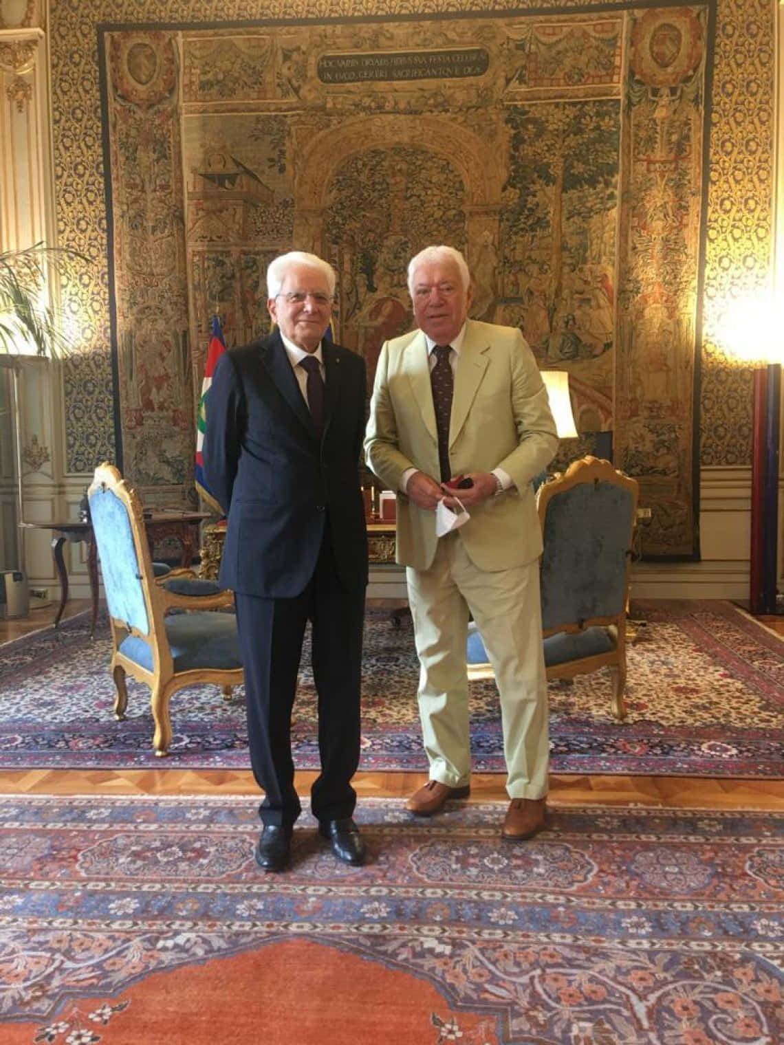 Two Gentlemen Standingin Ornate Room Background
