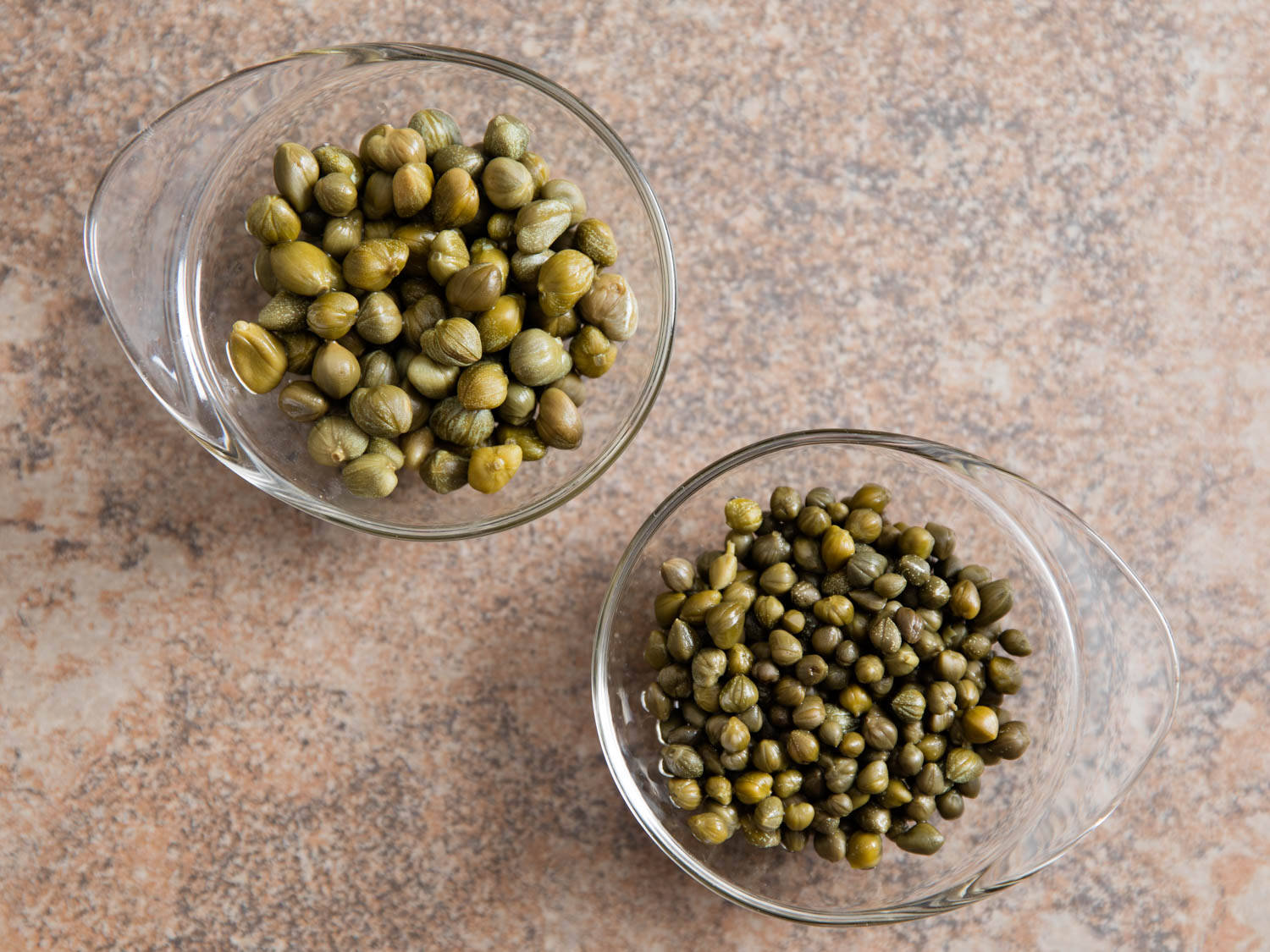 Two Glass Bowls Of Capers Background