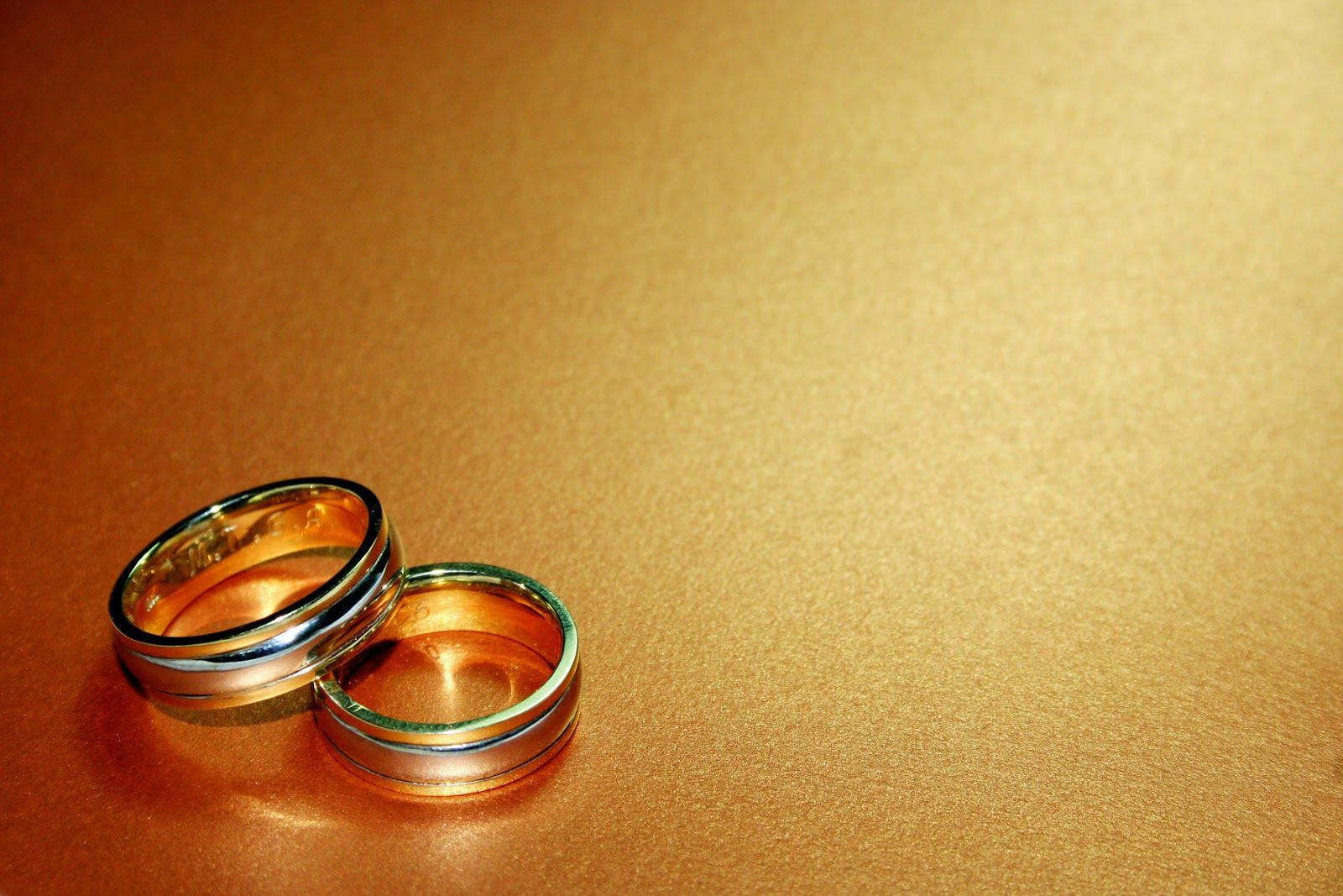 Two Gold Wedding Rings Background