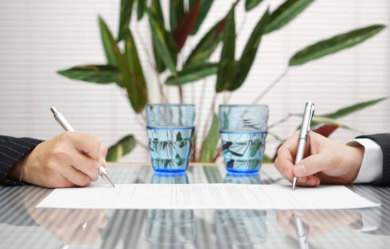 Two Hands Signing A Contract