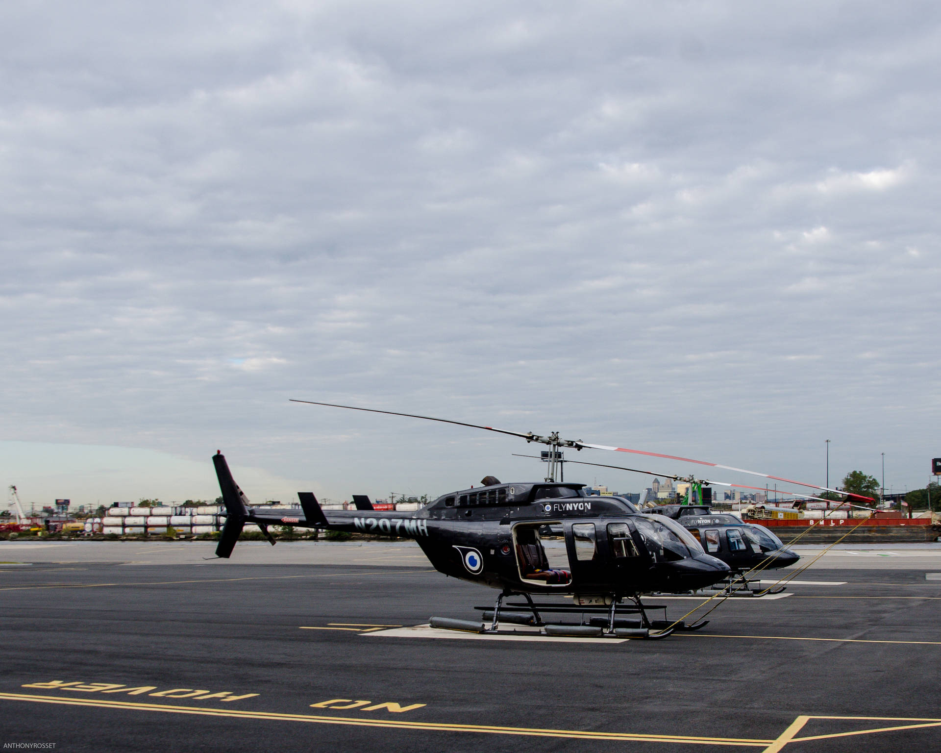 Two Helicopters Parked Background