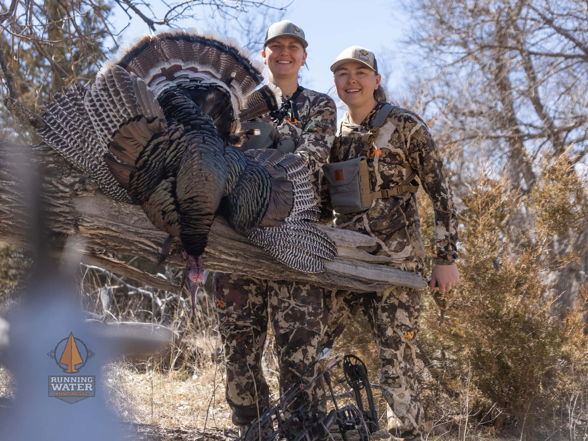 Two Hunters Pose With A Turkey Background